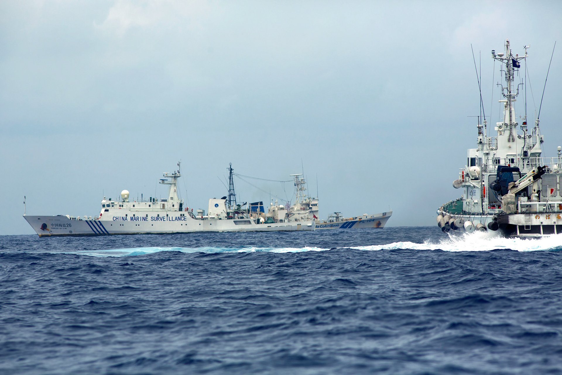 SENKAKU ISLANDS, Japan – Japanese Coast Guard vessel, right, sails along with Chinese maritime survellance ship Haijian No. 26, left, at Uotsuri-jima, Japan, May 26, 2013. Chinese government ships entered into the Japanese territorial waters of 46 times. (Photo by Osakabe Yasuo)