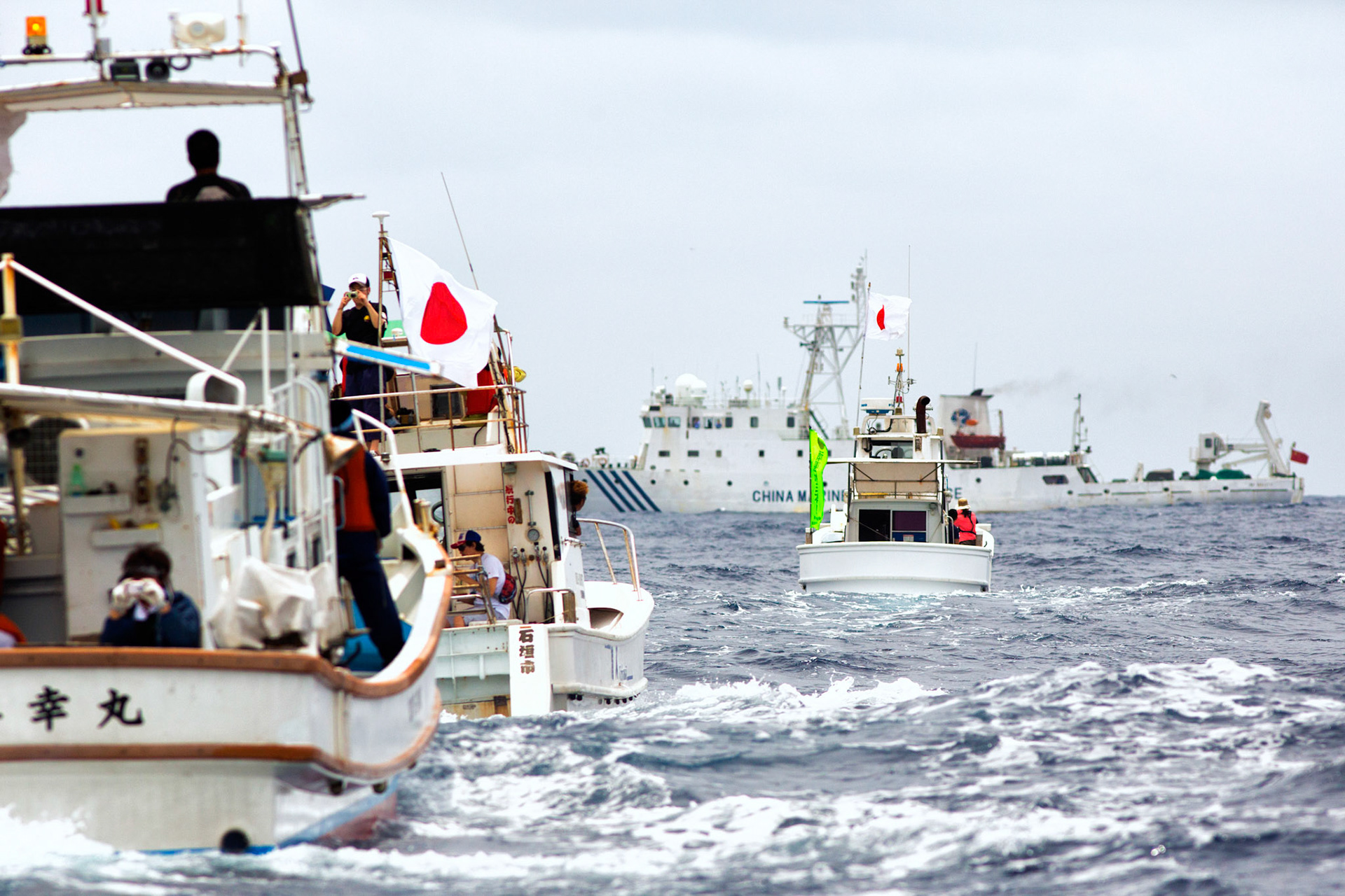 SENKAKU ISLANDS, Japan -- The Chinese maritime surveillance ship Haijian NO. 46 blocks out Japanese commercial fishing boats inside Japanese territorial waters at Uotsuri-jima, May 26, 2013. Chinese government ships entered into the Japanese territorial waters of 46 times. (Photo by Osakabe Yasuo)