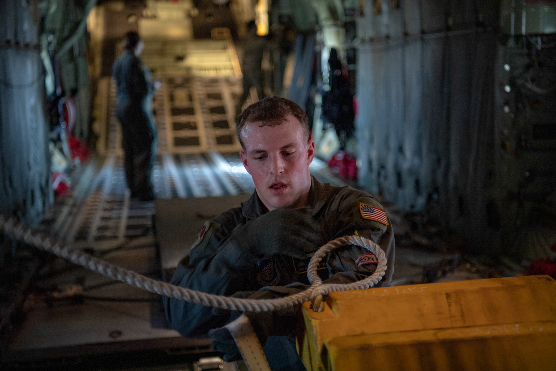 Airman 1st Class Matthew Pfeffer, 36th Airlift Squadron C-130J loadmaster, secure aircraft chocks after the Yokota C-130J Rodeo at Yokota Air Base, Japan, March 22, 2019. The Rodeo is a tactical airlift competition between flights within the 36th Airlift Squadron and 374th Operations Support Squadron, whose goal is to demonstrate capabilities, improve procedures, and enhance standardization for global operations.  (U.S. Air Force photo by Yasuo Osakabe)