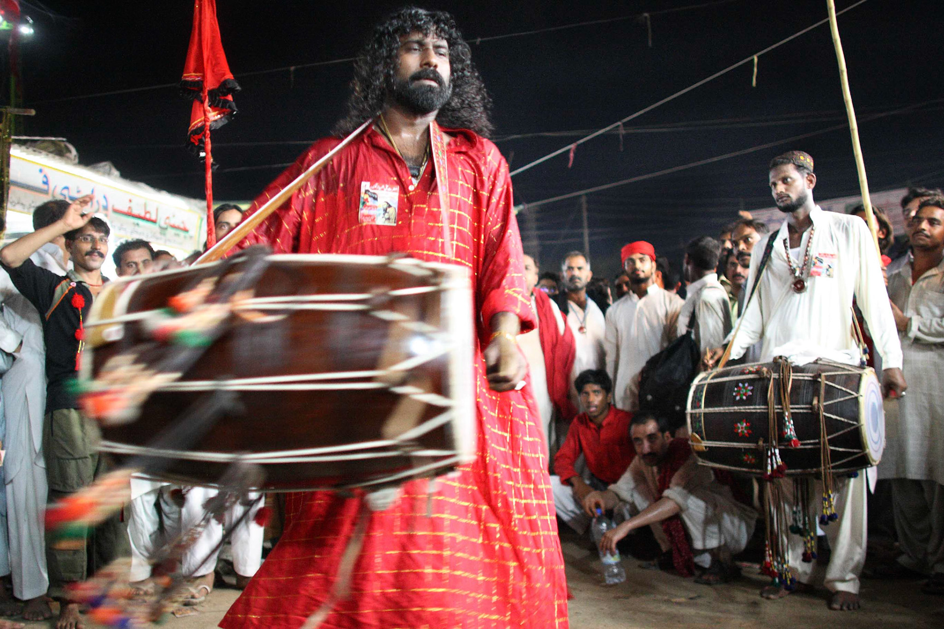 Gonga sain (front) and Mithu sain (back) played their sufi dhol beat by the shrine of Lal Shahbaz Qalandar by devotees. (Travel)