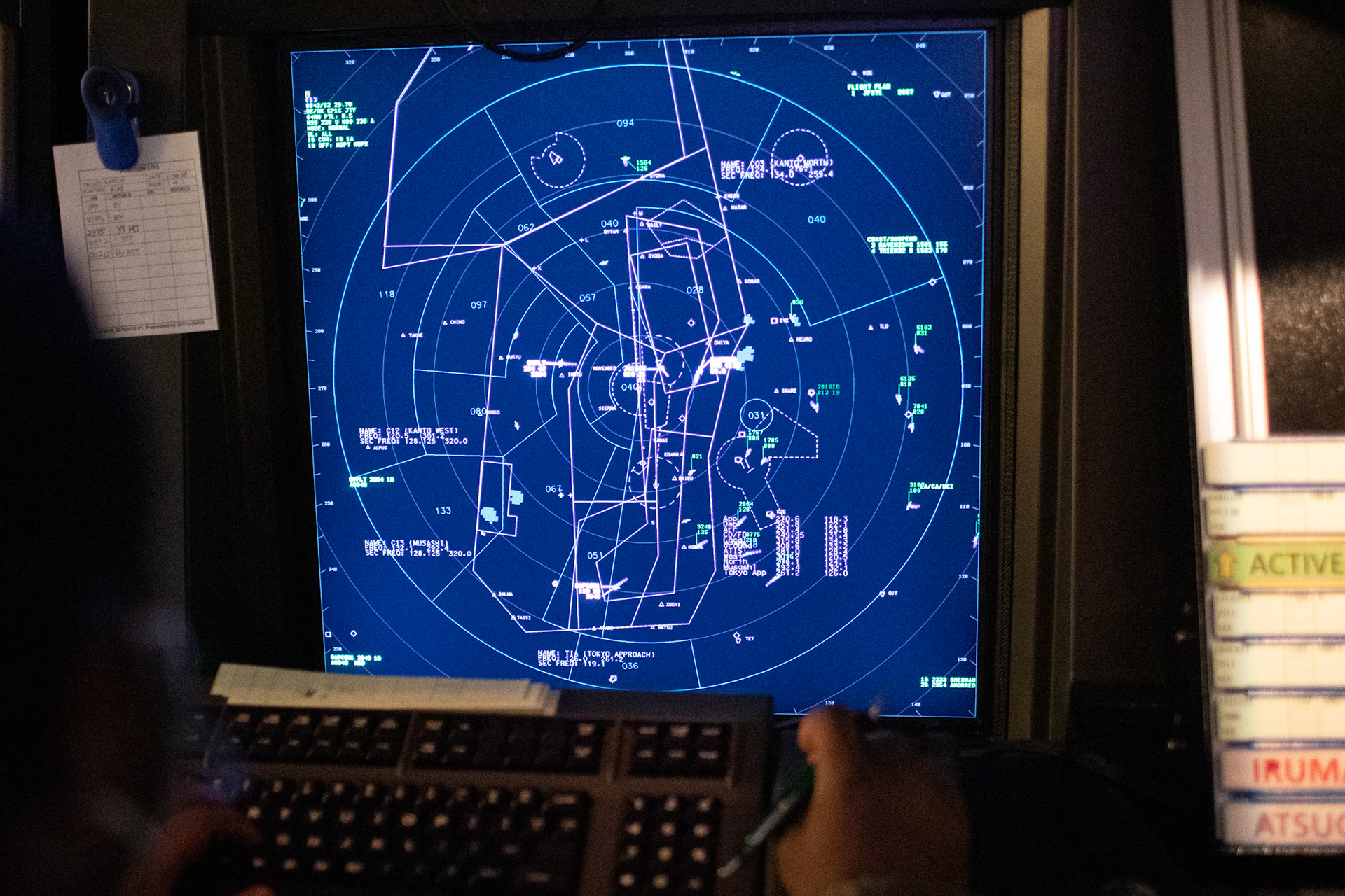 An air traffic controller with the 374th Operations Support Squadron air traffic control team reads radar scopes, June 11, 2020 at Yokota Air Base, Japan. Radar scopes allow air traffic controllers to view aircraft and local weather conditions, providing a safe operating environment for all aircraft in the coordinated airspace. (U.S. Air Force photo by Yasuo Osakabe)