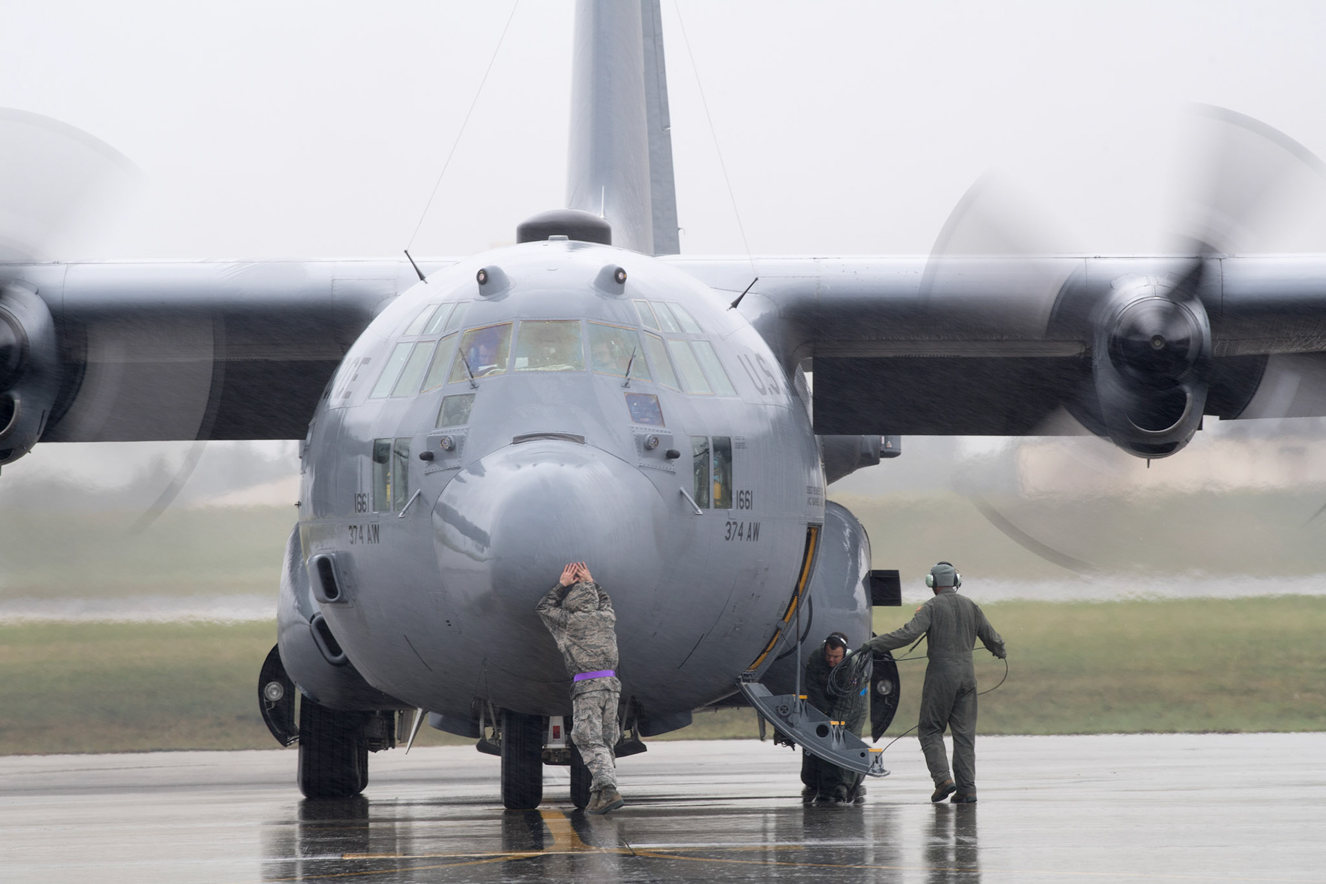 A crew chief from the 374th Aircraft Maintenance Squadron touches a nose of the C-130H Hercules before taxing at Yokota Air Base, Japan, Oct. 16, 2017. The 374th AMXS maintained 14 C-130H Hercules aircraft, which were responsible for the tactical airlift of an area of responsibility covering 50 percent of the globe. (U.S. Air Force photo by Yasuo Osakabe)