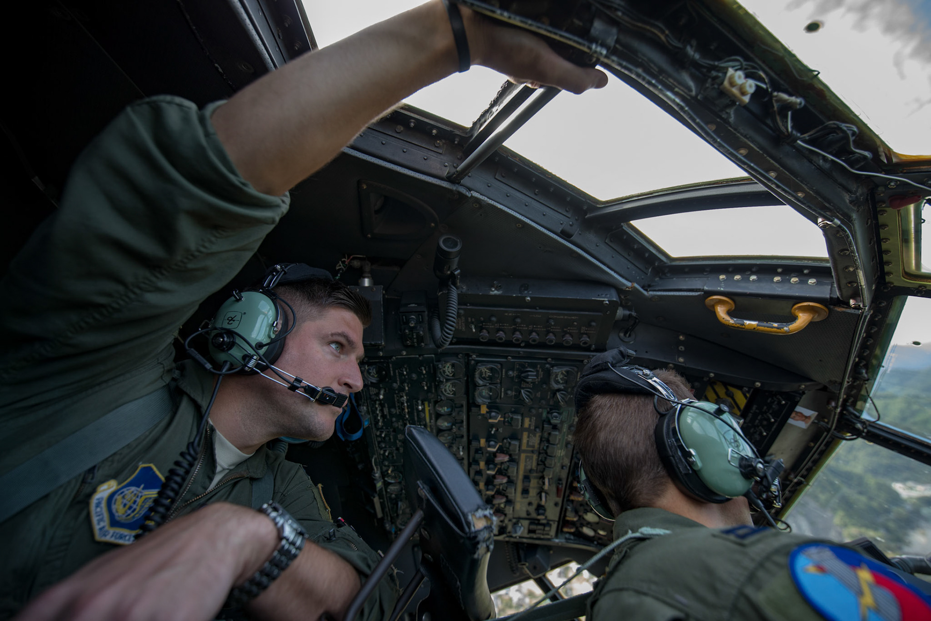 Capt. Andrew Kochman, 36th Airlift Squadron navigator, keeps a lookout while behind a co-pilot during a tactical training mission over Yamanashi Prefecture, Japan, Oct. 5, 2017. This is the last active duty C-130H Hercules tactical training sortie. (U.S. Air Force photo by Yasuo Osakabe)