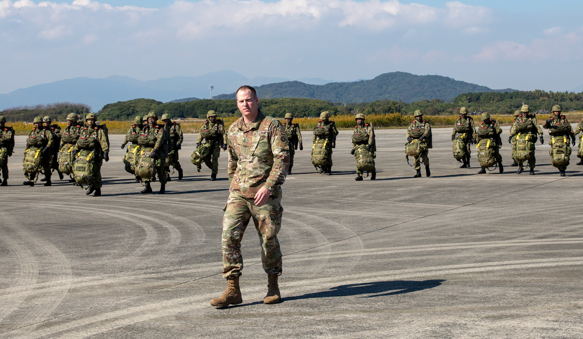 U.S. Army Master Sgt. Nathan Greer, U.S. Army Alaska jump master, leads Japan Ground Self-Defense Force paratroopers assigned to the 1st Airborne Brigade at Japan Air Self-Defense Force Tsuiki Air Base, Japan, Nov. 4, 2018, during Keen Sword 19. U.S. Army jump masters assigned to the USARAK supported JGSDF paratroopers as they jumped from U.S. Air Force C-130J Super Hercules aircraft. (U.S. Air Force photo by Yasuo Osakabe)