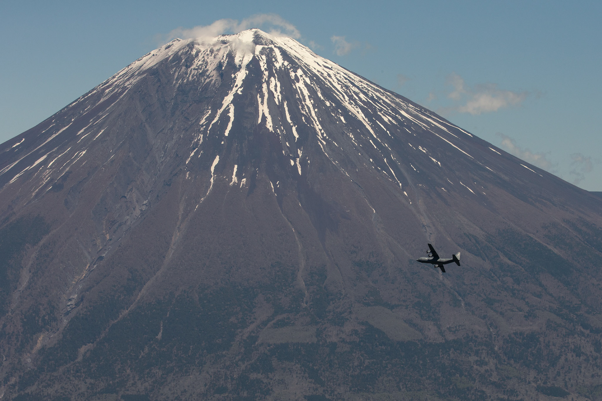 C-130J Super Hercules assigned to the 36th Airlift Squadron maneuvers by Mount Fuji, Japan, during the 374th Airlift Wing Generation Exercise, May 4, 2018. During the formation flight portion of the exercise, the aircrews flew together over the ocean, through mountainous terrain and dropped sand bags on Yokota’s airfield to test and improve on their humanitarian aid and disaster relief capabilities. (U.S. Air Force photo by Yasuo Osakabe)
