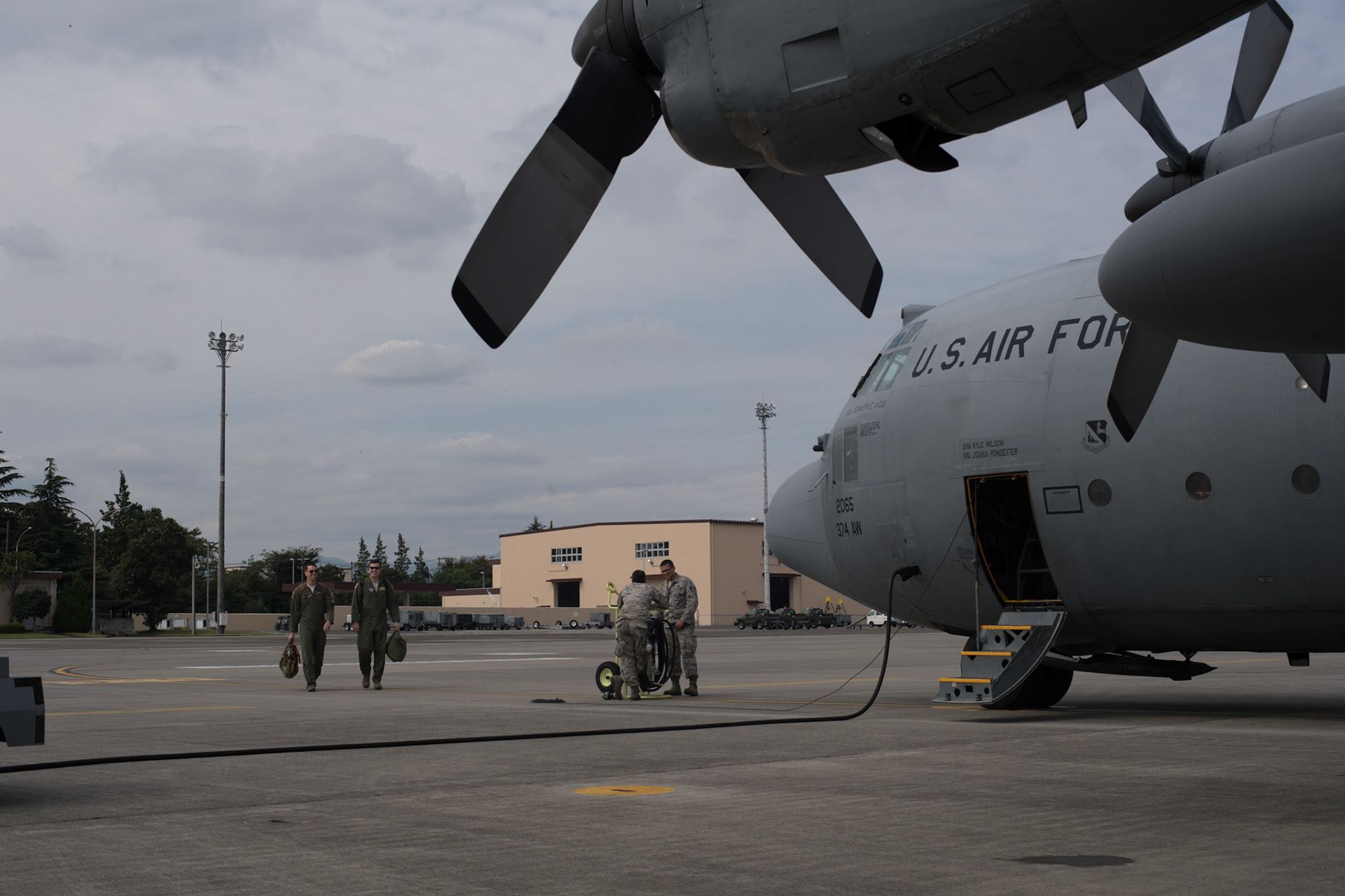 Crew members from the 36th Airlift Squadron walk on the flightline, at Yokota Air Base, Japan, Oct. 5, 2017. This is the last active duty C-130H Hercules tactical training sortie. (U.S. Air Force photo by Yasuo Osakabe)