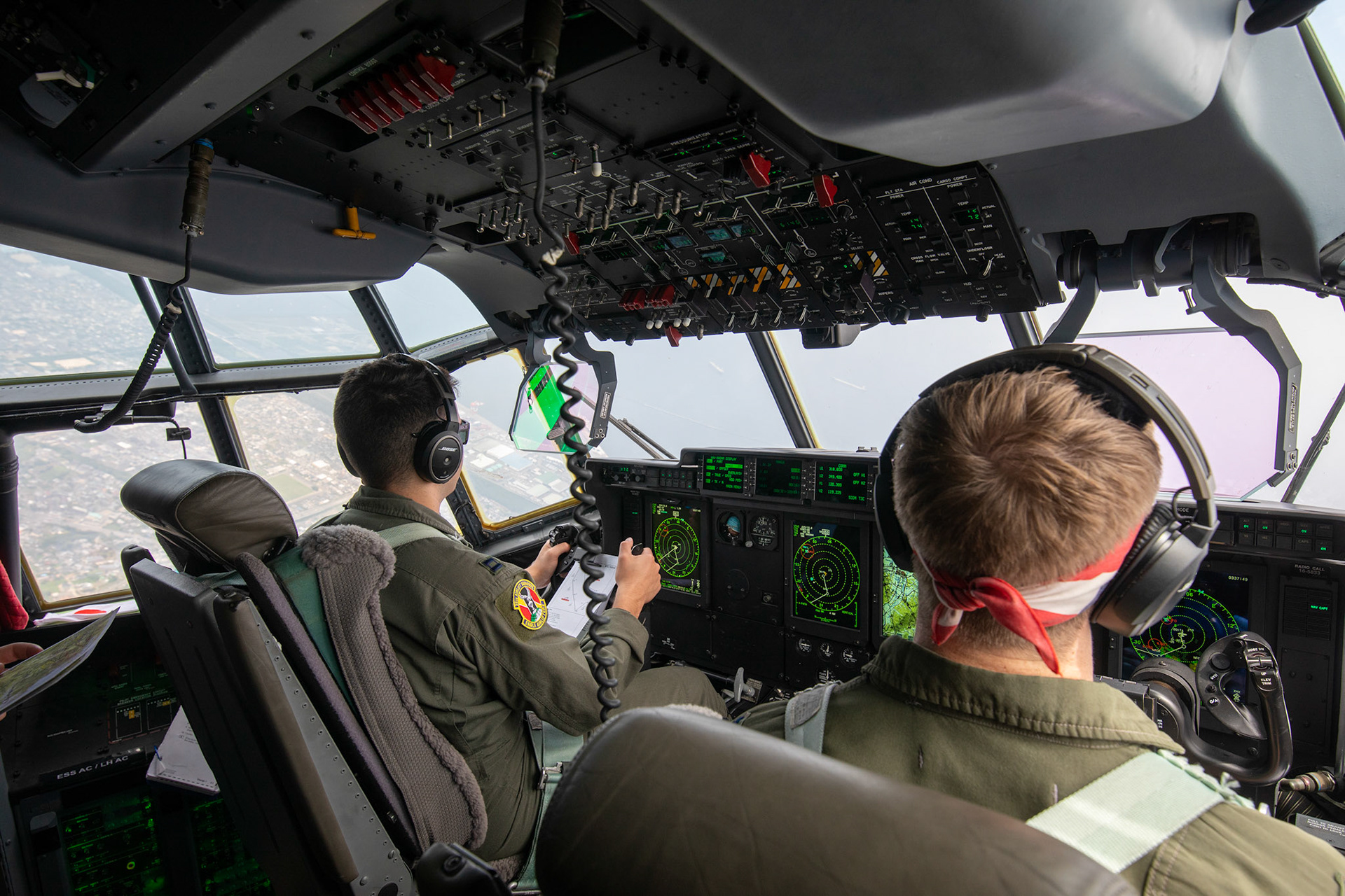 (Left to right) U.S. Air Force Capt. Evan Taylor and Capt. Michael Pyles, 36th Airlift Squadron C-130J pilots, fly over Kyushu, Japan, July 16, 2019, during a bilateral jump training. The training allows USAF and JGSDF units to work alongside each other while improving the readiness of our armed forces. (U.S. Air Force photo by Yasuo Osakabe)