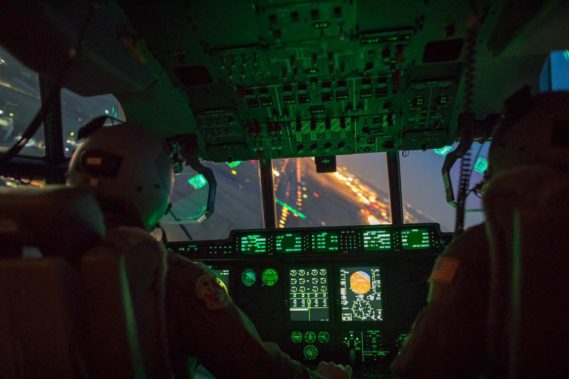 (Left to right) Capt. Andrew Huddleston and Maj. Christopher Carlen, both 36th Airlift Squadron C-130J pilots, approach a runway in a C-130J Super Hercules during a training mission at Yokota Air Base, Japan, March 26, 2018. Yokota aircrews regularly conduct night flying operations to ensure they are prepared for a variety of contingencies throughout the Indo-Asia Pacific region. (U.S. Air Force photo by Yasuo Osakabe)