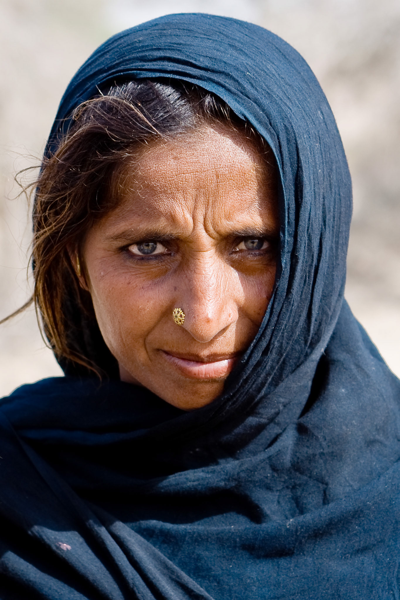 An elder lady with a lucid eyes in Cholistan desert. The tribe is still nomadic in the desert, Pakistan.