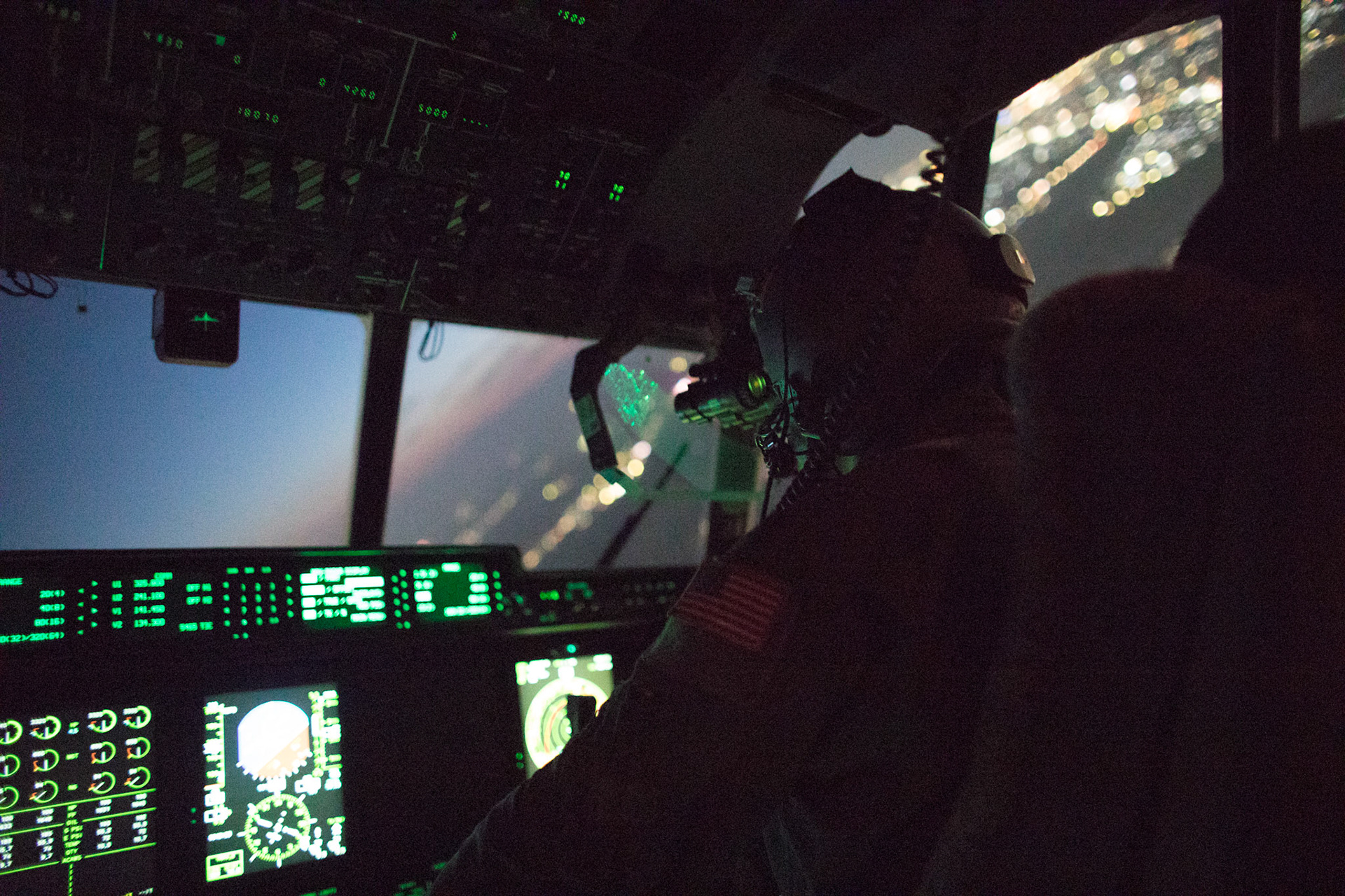 Maj. Christopher Carlen, 36th Airlift Squadron C-130j pilot, wears night vision goggle during a training mission above Yokota Air Base, Japan, March 26, 2018. Yokota aircrews regularly conduct night flying operations to ensure they are prepared for a variety of contingencies throughout the Indo-Asia Pacific region. (U.S. Air Force photo by Yasuo Osakabe)