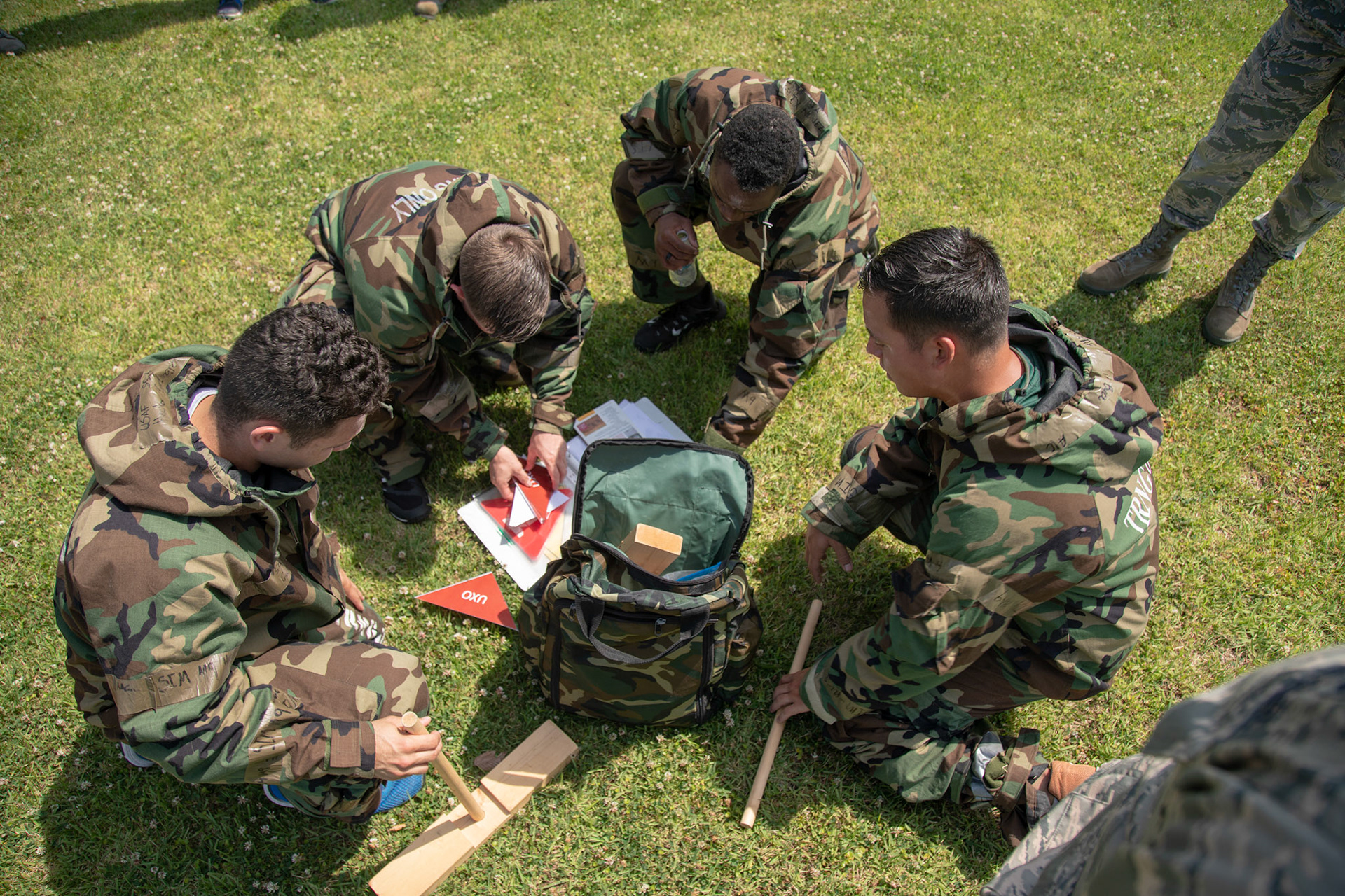 Airmen with the 374th Civil Engineer Squadron prepare to perform a post attack reconnaissance check during an Ability to Survive and Operate (ATSO) Rodeo at Yokota Air Base, Japan, June 8, 2018. The rodeo involved participants wearing different stages of mission-oriented protective posture (MOPP) gear after pushing a Humvee and going through various areas of training including self-aid and buddy care, post-attack reconnaissance, four-person relay, and "shoot, move and communicate." (U.S. Air Force photo by Yasuo Osakabe)