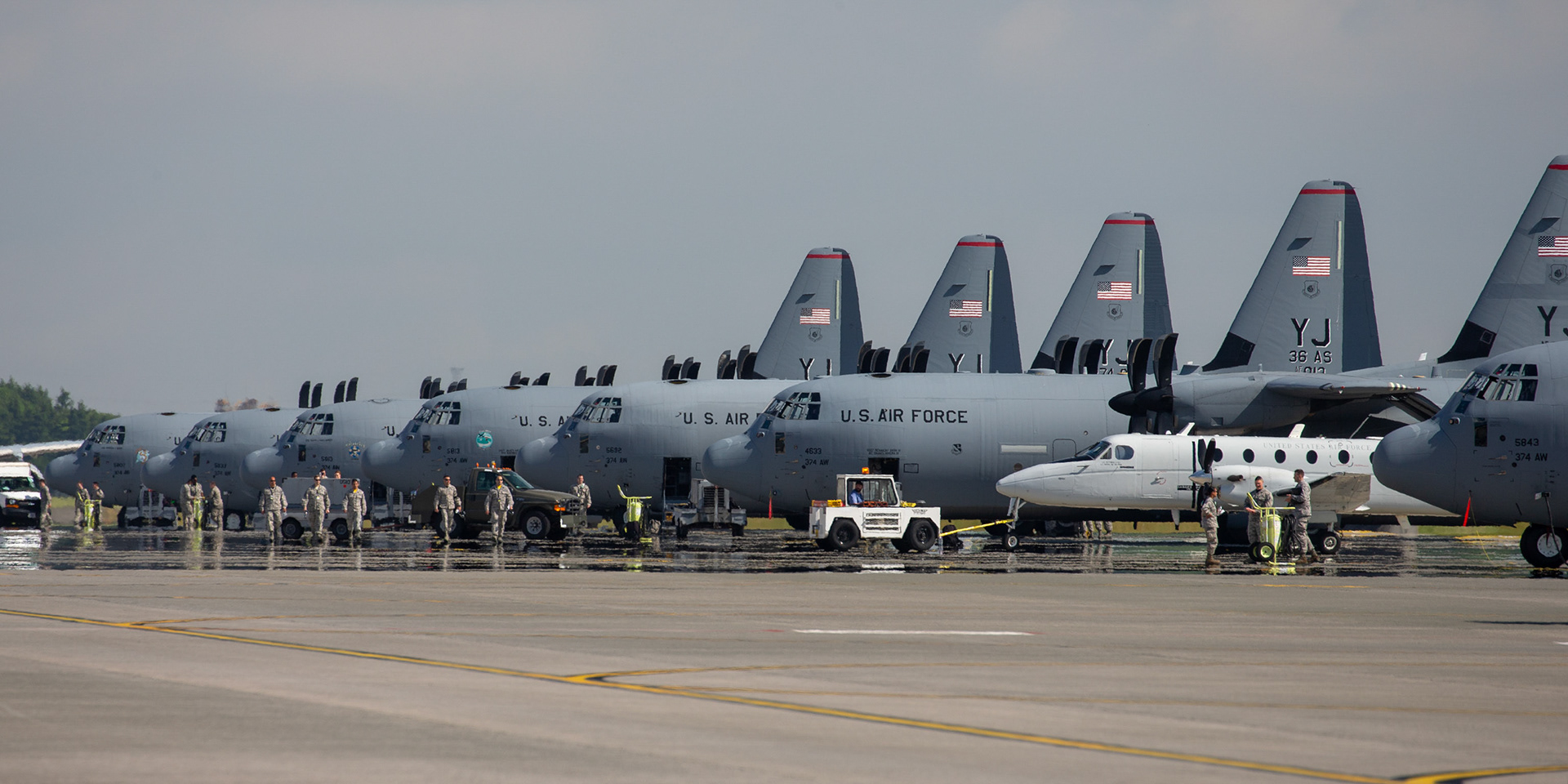 C-130J Super Hercules and a C-12 Huron sit on the flightline during the 347th Airlift Wing (AW) Generation Exercise Elephant Walk at Yokota Air Base, Japan, May 4, 2018.  The 374 AW conducted the exercise to train the wing’s ability to rapidly provide humanitarian aid and disaster relief throughout the Indo-Pacific region. (U.S. Air Force photo by Yasuo Osakabe)