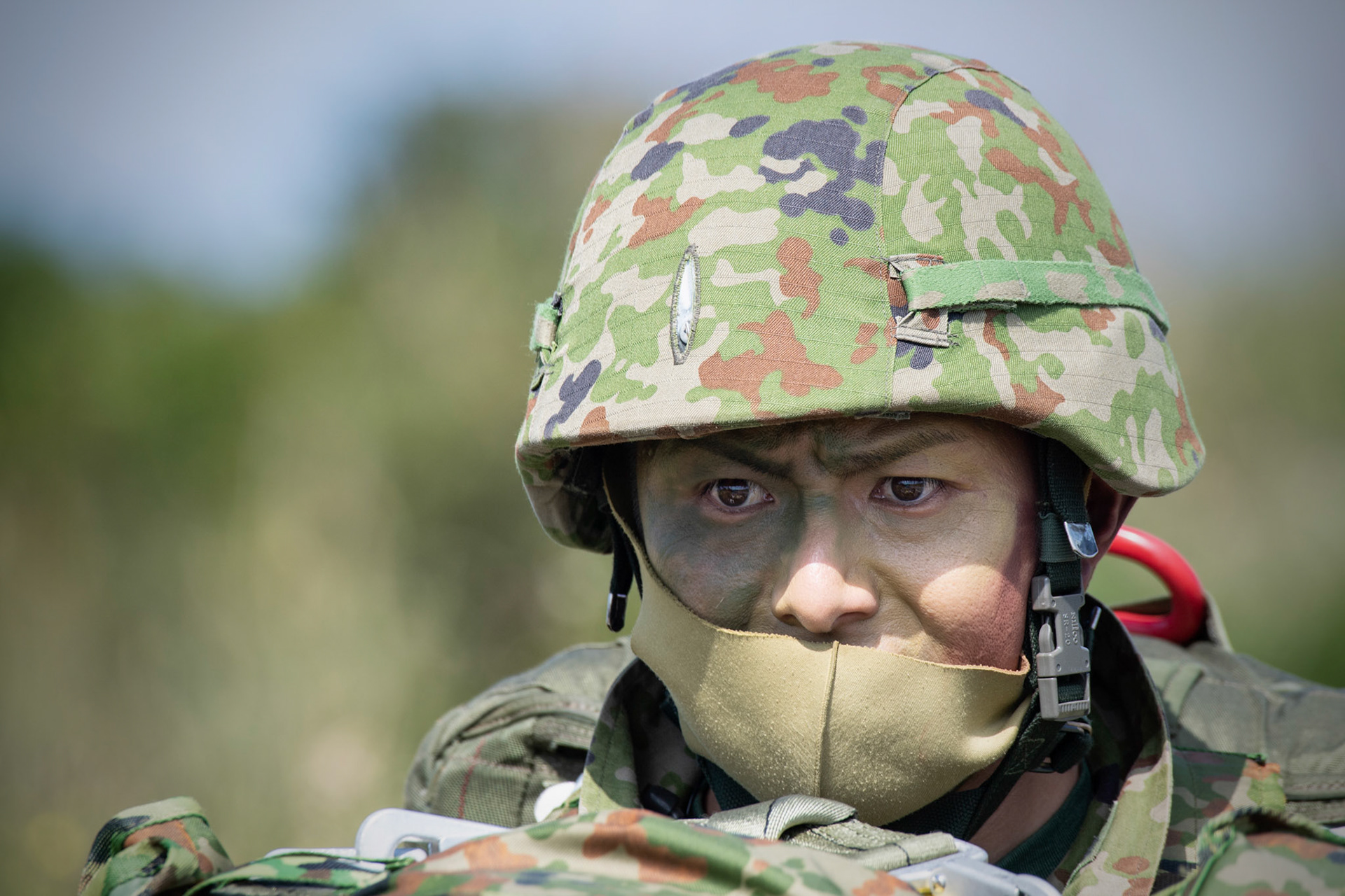 A Japan Ground Self-Defense Force paratrooper assigned to the 1st Airborne Brigade carries his equipment after landing at Kikaijima Island, Japan, March 3, 2023, during Field Training Exercise Iron Fist 23. During the exercise, the USAF and Japan Self-Defense Forces conducted simulated island seizure airborne operations as the U.S. Marine Corps performed a simultaneous amphibious assault onto the beachhead. (U.S. Air Force photo by Yasuo Osakabe)