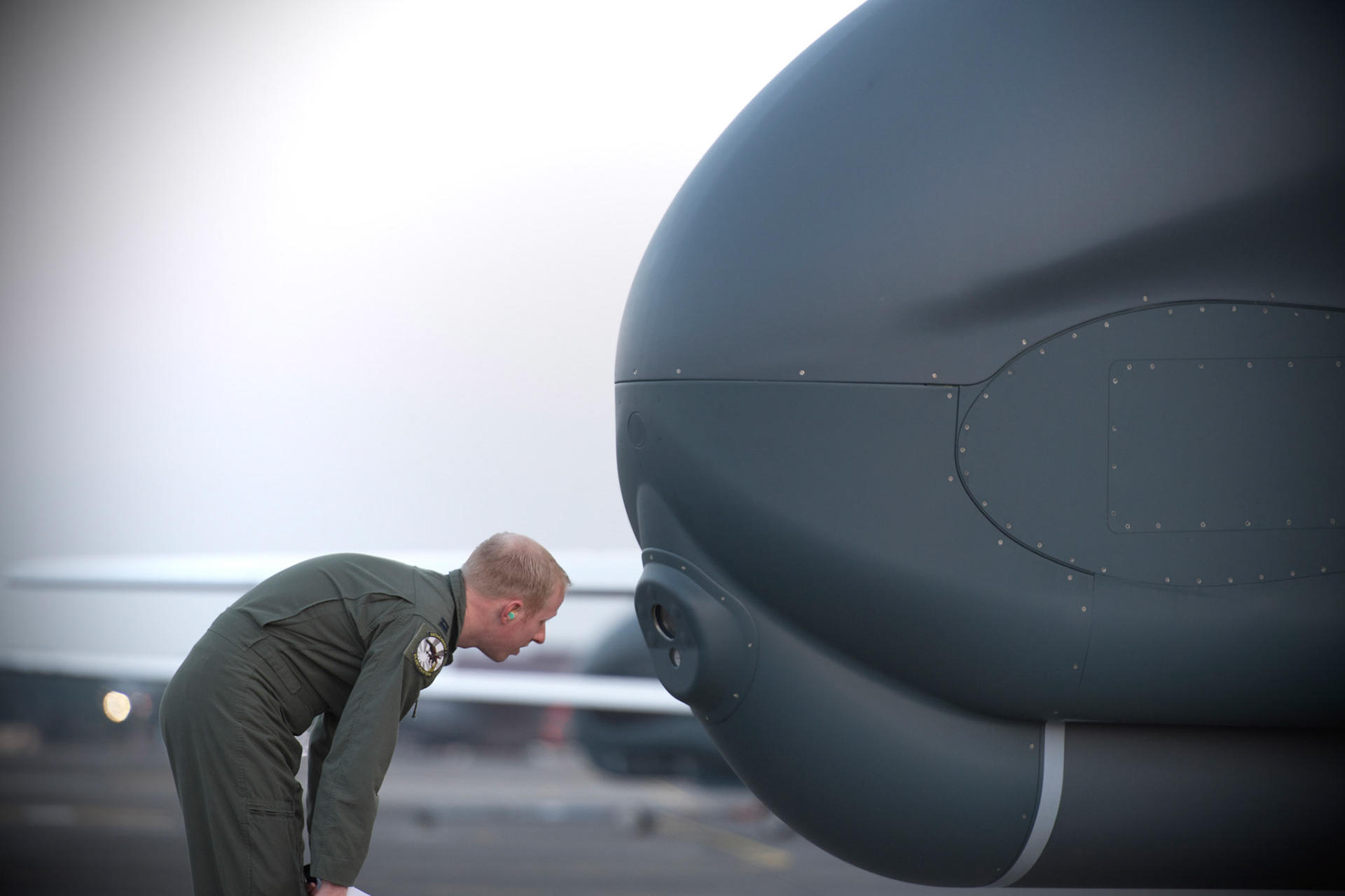Capt. Mark, 69th Reconnaissance Group Detachment 1 RQ-4 pilot, inspects a front camera on a RQ-4 Global Hawk at Yokota Air Base, Japan, May 5, 2017. The RQ-4 Global Hawk is a high-altitude, long-endurance, remotely piloted aircraft system with an integrated sensor suite that provides intelligence, surveillance, and reconnaissance information to joint forces worldwide. (U.S. Air Force photo by Yasuo Osakabe)