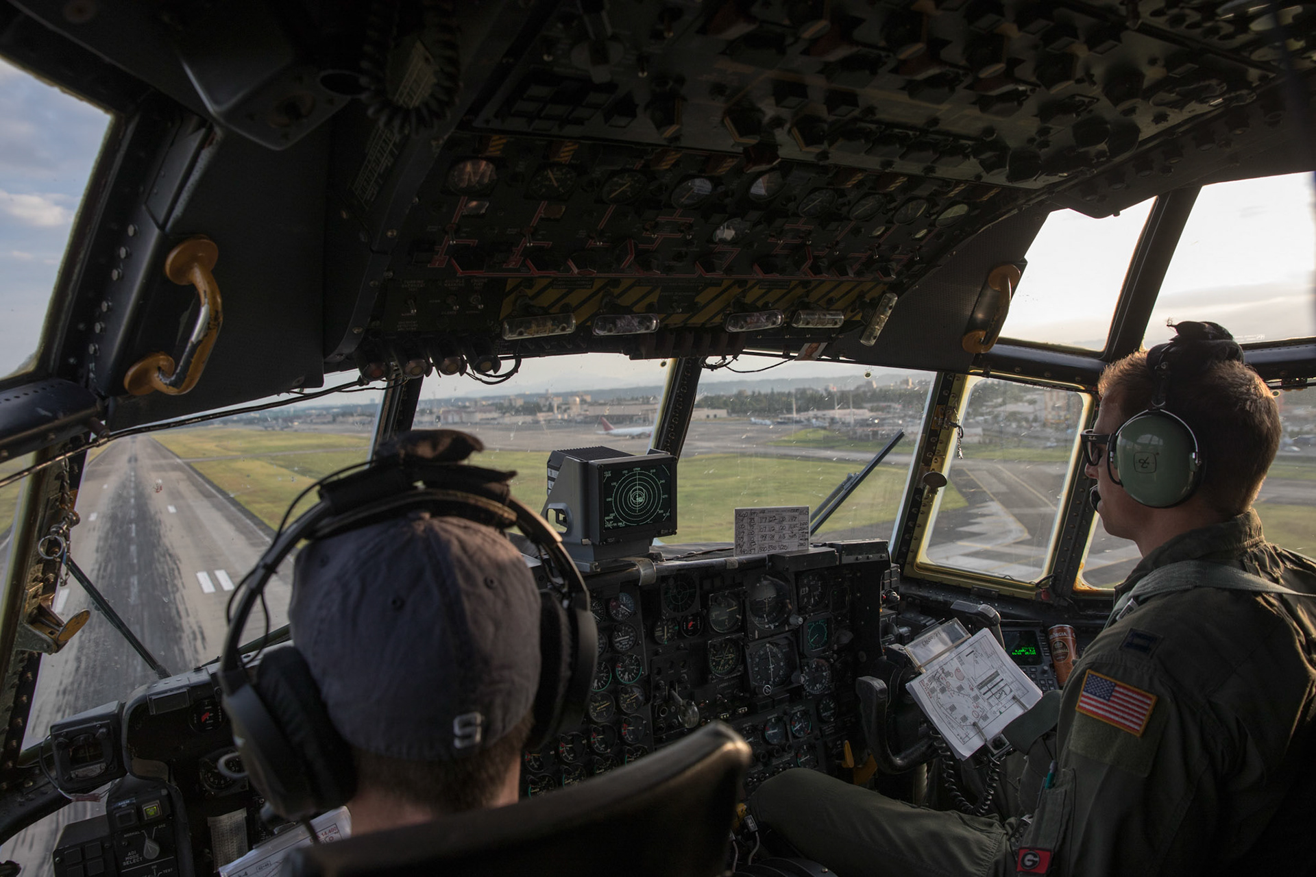 Lt. Col. John Kerr, left, and Capt. Thomas Bernard, 36th Airlift Squadron C-130H pilots, fly over Yokota Air Base, Japan, during a tactical training sortie, Oct. 5, 2017. This is the last active duty C-130H Hercules tactical training sortie. (U.S. Air Force photo by Yasuo Osakabe)
