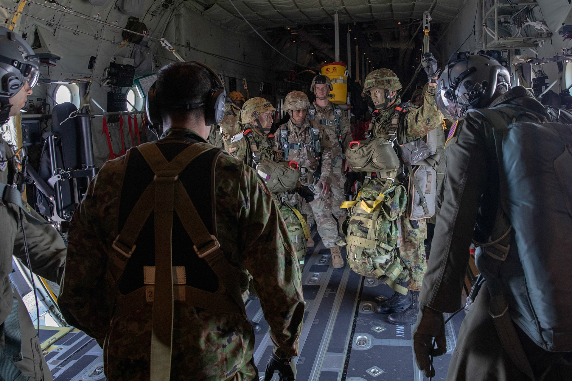 Japan Ground Self-Defense Force soldiers assigned to the 1st Airborne Brigade confirm their delivery procedures over Hiju-dai drop zone, Oita prefecture, Japan, Nov. 4, 2018, during Keen Sword 19. Approximately 280 JGSDF personnel conducted jump training from U.S. Air Force C-130J Super Hercules’ for the first time in Japan. (U.S. Air Force photo by Yasuo Osakabe)