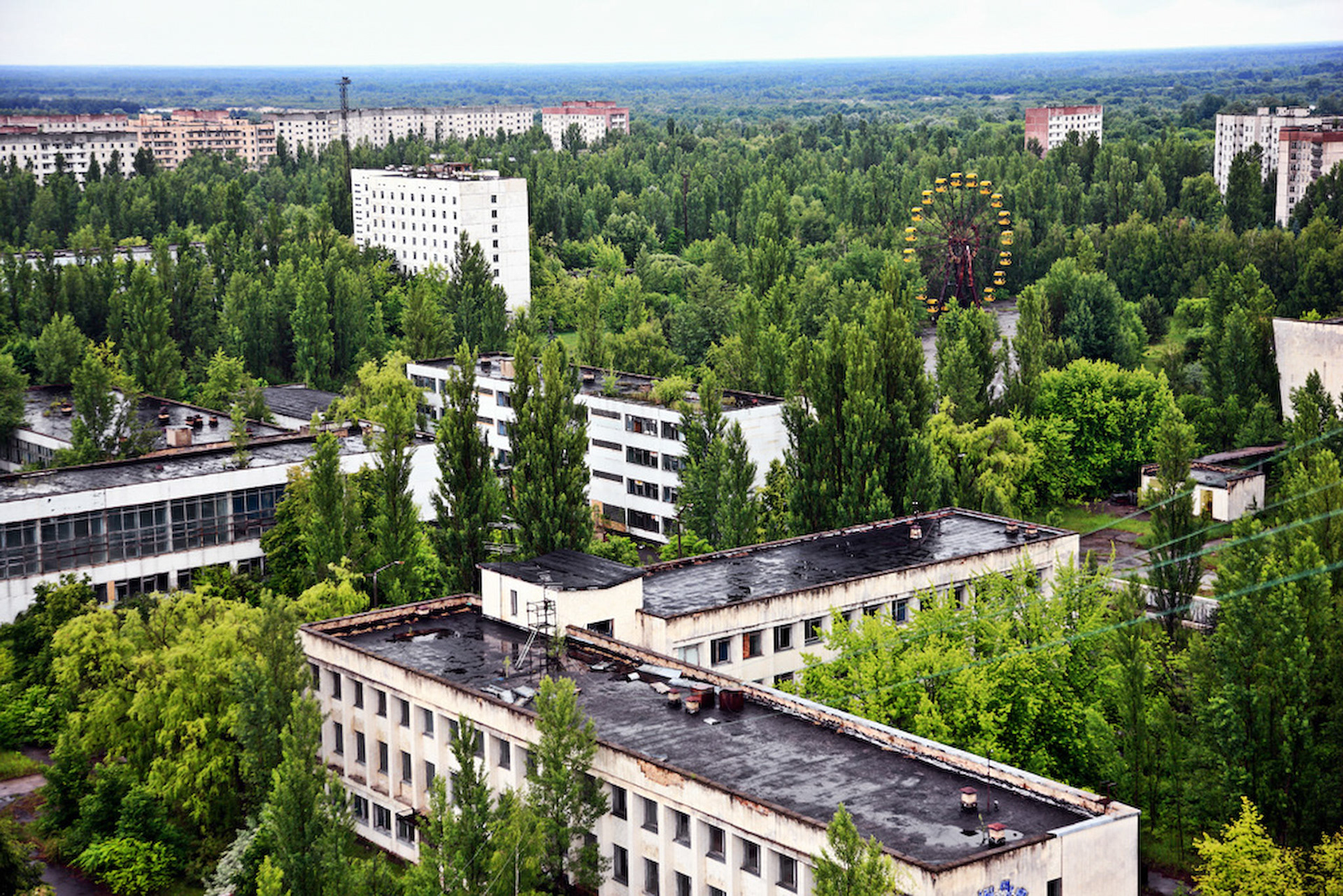 Pripyat is an abandoned city in the zone of alienation in northern Ukraine, Kiev Oblast, near the border with Belarus. The city was founded in 1970 to house the Chernobyl Nuclear Power Plant workers, and was abandoned in 1986 following the Chernobyl disaster. Its population had been around 50,000 prior to the accident. This view is from 16-storeyed building near by the center of Pripyat town.