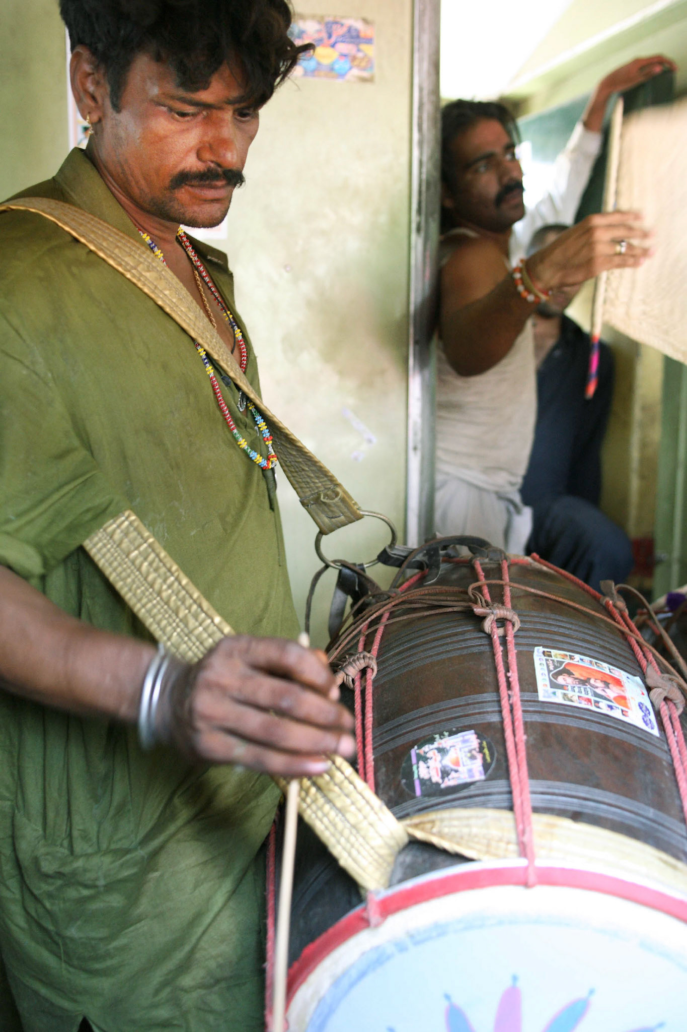 Jhura sain (sufi dhol player) was playing the sufi beat with his master, Pappu sain for the passengers under a scorching hot. Jhura sain serves out Pappu sain apprenticeship as over 20 years. (Travel)