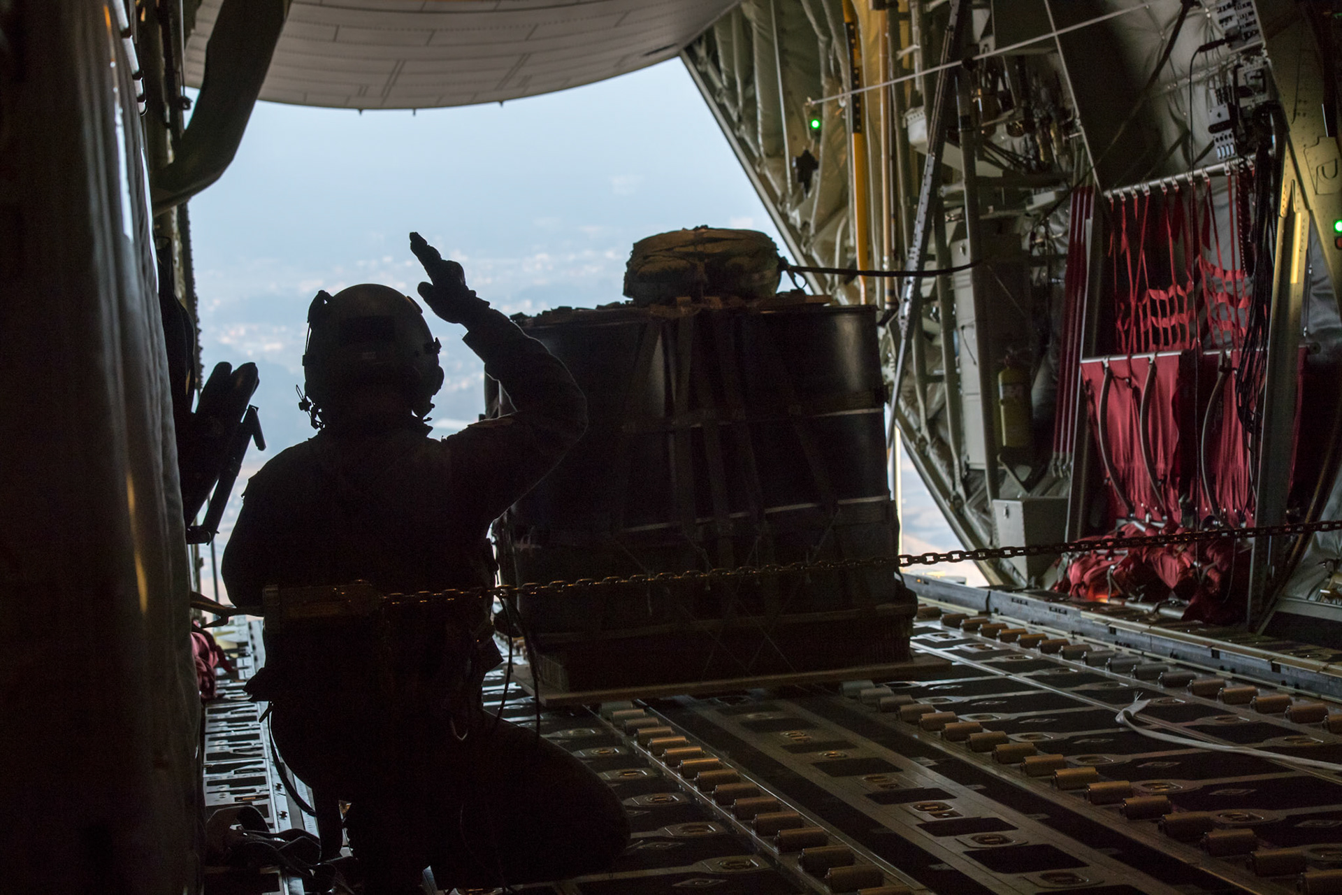 Airman 1st Class Matthew Pfeffer, 36th Airlift Squadron C-130J loadmaster, performs a Container Delivery System (CDS) bundle airdrop over Combined Arms Training Center Camp Fuji, Japan, March 26, 2018. CDS are most commonly used for quick aerial insertion of supplies for military and contingency operations. Bundles are used as a means of delivering equipment too heavy for the individual jumper to carry.  (U.S. Air Force photo by Yasuo Osakabe)