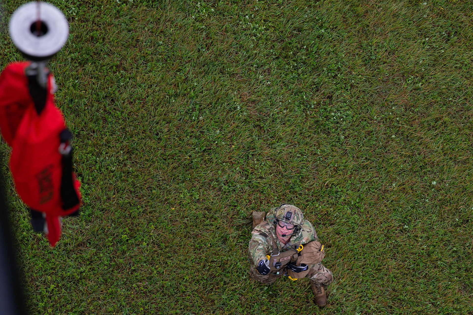 Tech. Sgt. Justin Bender, 374th Operations Support Squadron survival, evasion, resistance and escape specialist, is ready to hoist up after performing a simulated rescue mission during a Capabilities Exercise as part of the 2018 Japanese-American Friendship Festival at Yokota Air Base, Japan, Sept. 15, 2018. Members with the 459th AS showcased their rescue capabilities to execute search-and-rescue mission. (U.S. Air Force photo by Yasuo Osakabe)