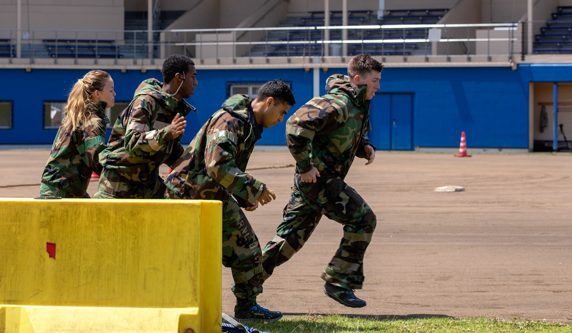 Airmen with the 374th Security Forces Squadron run to the next stage during an Ability to Survive and Operate (ATSO) Rodeo at Yokota Air Base, Japan, June 8, 2018. The rodeo involved participants wearing different stages of mission-oriented protective posture (MOPP) gear after pushing a Humvee and going through various areas of training including self-aid and buddy care, post-attack reconnaissance, four-person relay, and "shoot, move and communicate." (U.S. Air Force photo by Yasuo Osakabe)