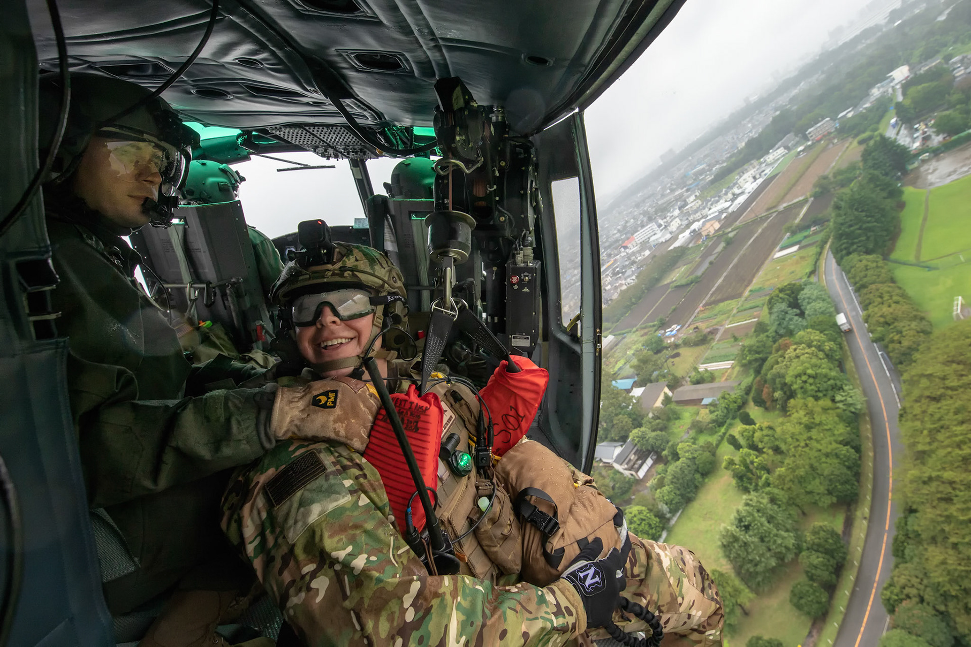 Tech. Sgt. Nicholas Poe, 459th Airlift Squadron special mission aviator and Tech. Sgt. Justin Bender, 374th Operations Support Squadron survival, evasion, resistance and escape specialist, talk  during a Capabilities Exercise as part of the 2018 Japanese-American Friendship Festival at Yokota Air Base, Japan, Sept. 15, 2018. Members with the 459th AS showcased their rescue capabilities to execute search-and-rescue mission. (U.S. Air Force photo by Yasuo Osakabe)