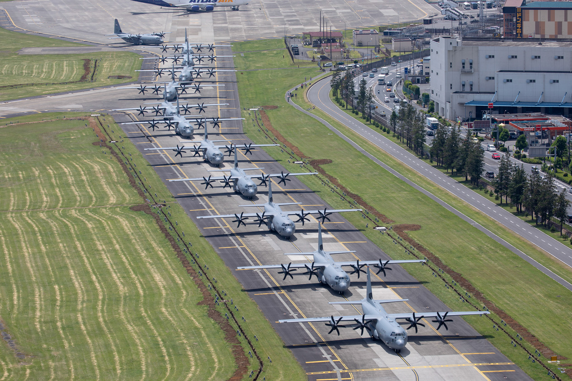 Twelve C-130J Super Hercules from the 36th Airlift Squadron take part in an elephant walk before taking off during the 374th Airlift Wing (AW) Generation Exercise at Yokota Air Base, Japan, May 4, 2018.  The 374th AW conducted the exercise to train the wing’s ability to rapidly provide humanitarian aid and disaster relief throughout the Indo-Pacific region. (U.S. Air Force photo by Yasuo Osakabe)