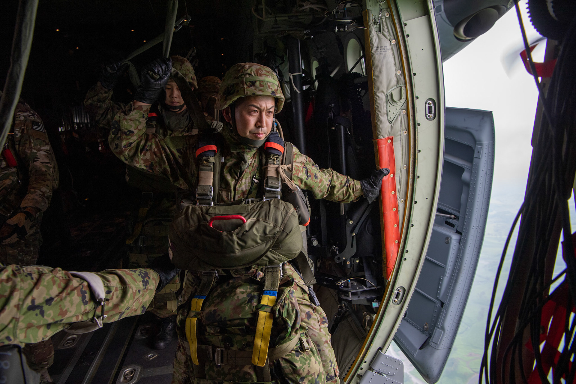 A Japan Ground Self-Defense Force soldier assigned to the 1st Airborne Brigade jumps from a U.S. Air Force C-130J Super Hercules from the 36th Airlift Squadron over Hiju-dai exercise area, Oita prefecture, Japan, July 16, 2019, during a bilateral jump training. The training allows USAF and JGSDF units to work alongside each other while improving the readiness of our armed forces. (U.S. Air Force photo by Yasuo Osakabe)