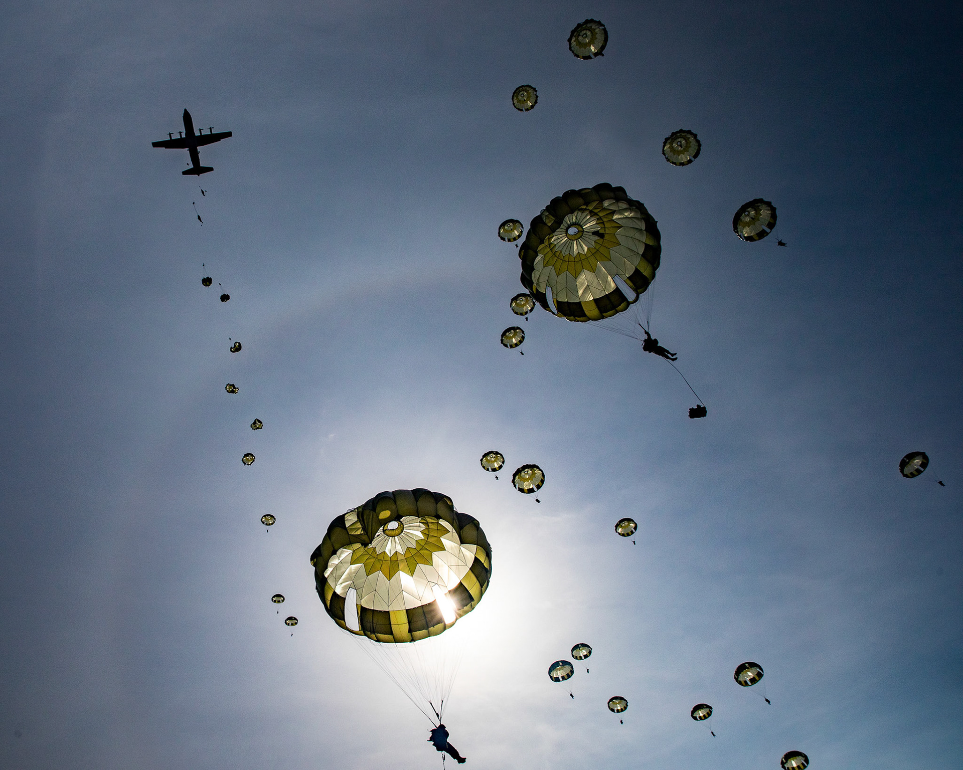 Japan Ground Self-Defense Force Soldier assigned to the 1st Airborne Brigade descend from a U.S. Air Force C-130J Super Hercules assigned to the 36th Airlift Squadron over Combined Arms Training Center Camp Fuji, Japan, March 9, 2021, during Airborne 21 exercise. Airborne 21 was the largest U.S.- Japan airborne operation in history; involving approximately 600 JGSDF paratroopers, 12 C-130s' aircraft and 130 containment delivery system bundles. (U.S. Air Force photo by Yasuo Osakabe)