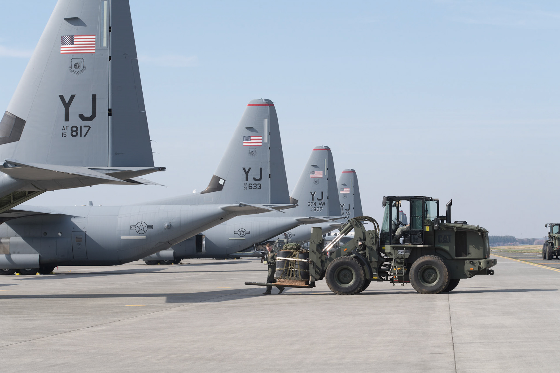 Airmen with the 374th Logistics Readiness Squadron and 36th Airlift Squadron load a Container Delivery System (CDS) bundle onto a C-130J Super Hercules at Yokota Air Base, Japan, March 26, 2018. The 374th LRS combat mobility flight maintain and prepare aerial cargo delivery systems and equipment for use during training exercises and real-world deployments. (U.S. Air Force photo by Yasuo Osakabe)