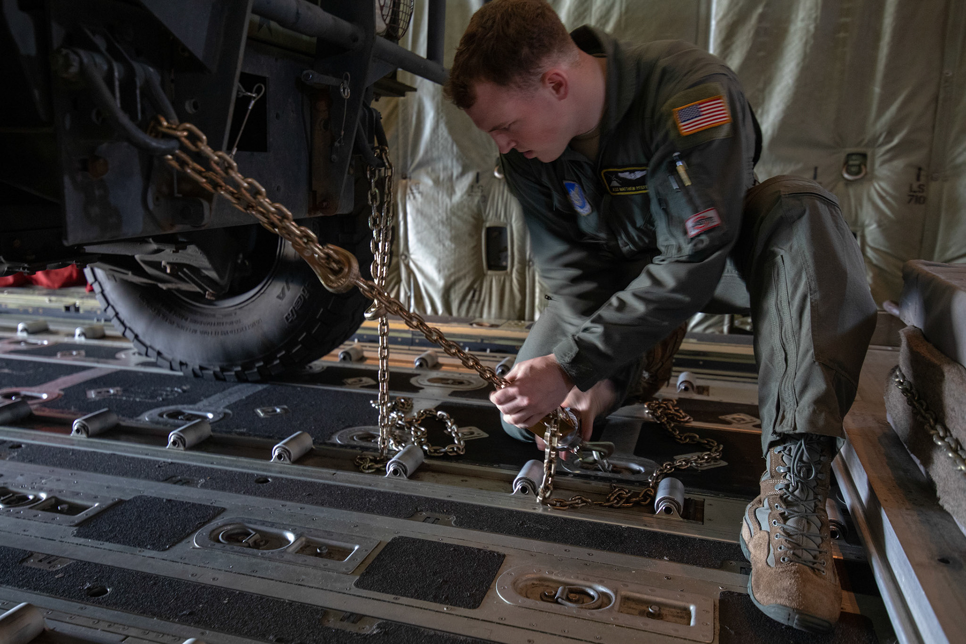 Airman 1st Class Matthew Pfeffer, 36th Airlift Squadron loadmaster, secure a Humvee vehicle to a C-130J Super Hercules during the Yokota C-130J Rodeo at Yokota Air Base, Japan, March 22, 2019. Two of six events that make up the Rodeo competition was a reverse taxi and a Humvee vehicle on and off-load which judged both pilots and loadmasters on their ability to successfully complete the tasks. (U.S. Air Force photo by Yasuo Osakabe)