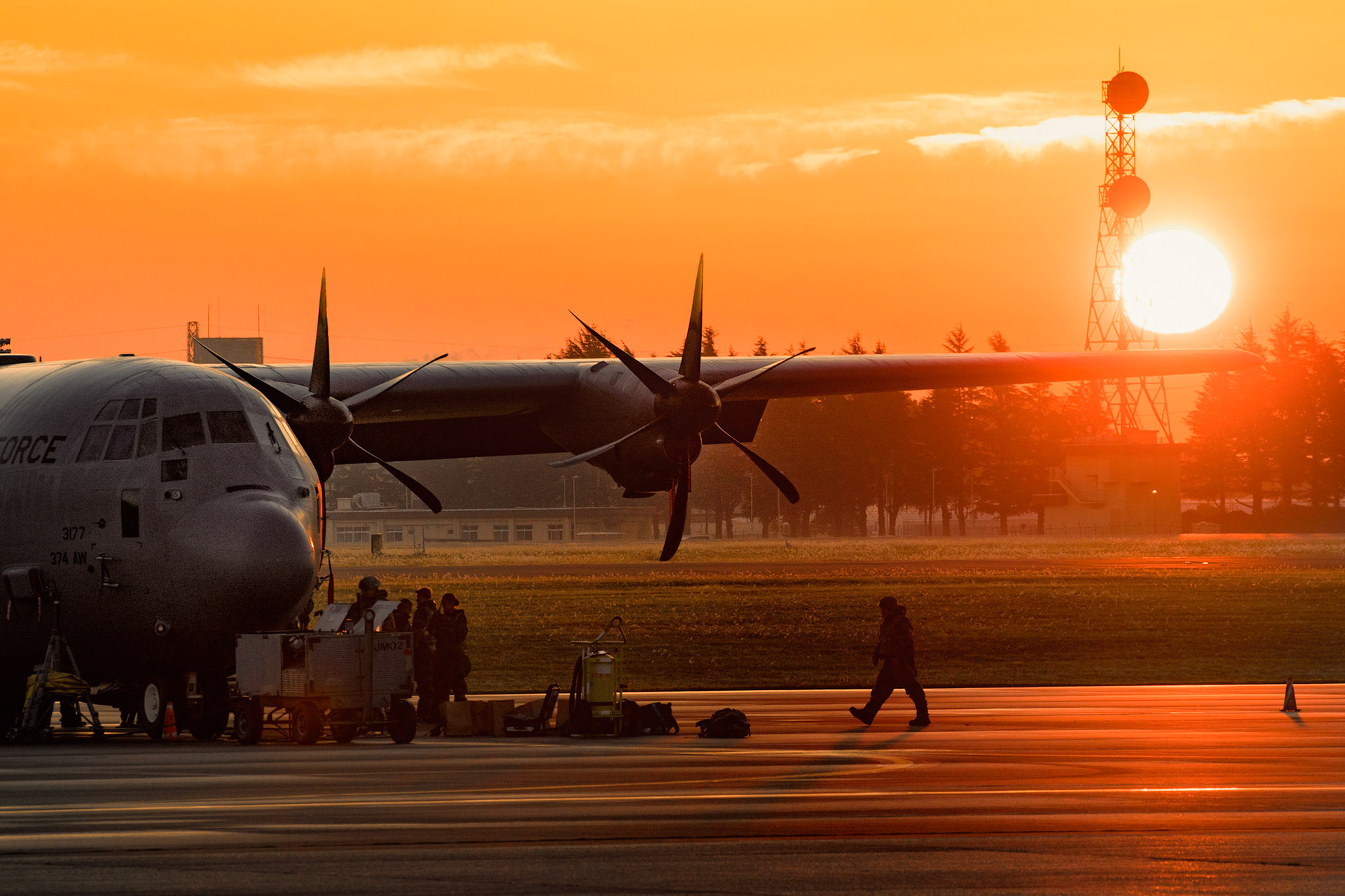 A crew chief assigned to the 374th Aircraft Maintenance Squadron walks on the flightline during the Exercise Beverly Morning 17-06 at Yokota Air Base, Japan, Oct. 26, 2017. Yokota received the C-130J Super Hercules from Dyess Air Force Base, Texas, and crew chiefs maintain the aircraft 24/7. (U.S. Air Force photo by Yasuo Osakabe)