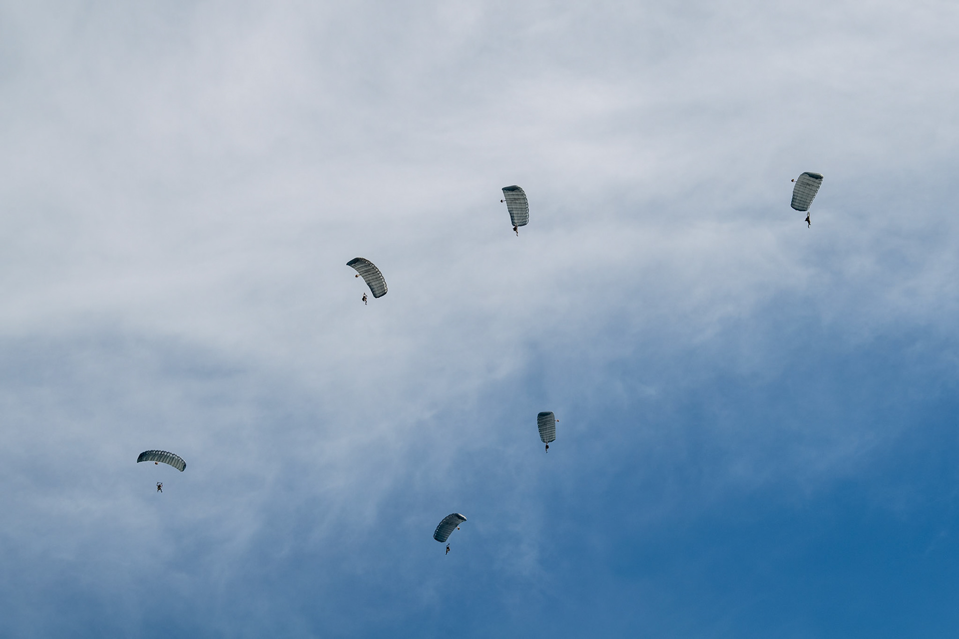 U.S Army soldiers from the 1st Battalion, 1st Special Forces Group (Airborne) parachute from a U.S. Air Force C-130J Super Hercules assigned to the 36th Airlift Squadron over Yokota Air  Base, Japan, June 17, 2020, during Exercise Gryphon Jet. Gryphon Jet is an integrated training exercise focused on improving interoperability throughout the special operations community. (U.S. Air Force photo by Yasuo Osakabe)