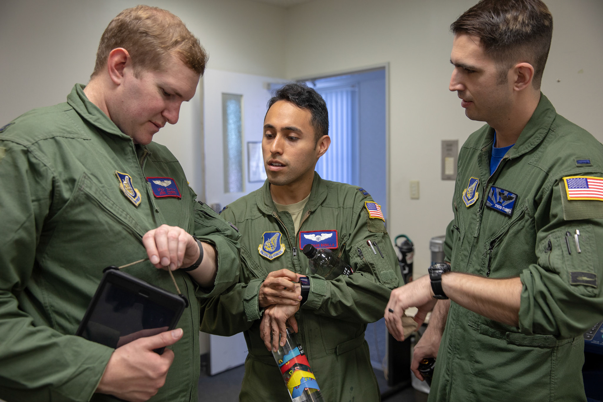 Pilots assigned to the 459th Airlift Squadron check their watches to make sure all the pilot‘s watches are synchronized during the 374th Airlift Wing (AW) Generation Exercise Elephant Walk at Yokota Air Base, Japan, May 4, 2018. The 374th AW operates a mission ready fleet of C-130J Super Hercules, C-12 Hurons and UH-1N Iroquois as the primary Western Pacific airlift hub for U.S. Air Force peacetime and contingency operations. (U.S. Air Force photo by Yasuo Osakabe)