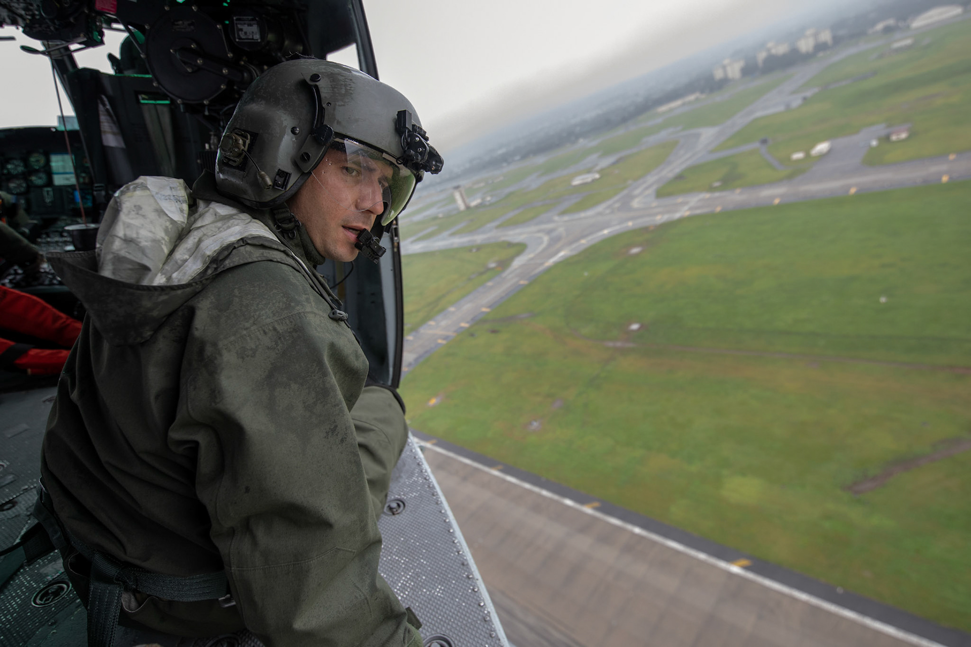 Tech. Sgt. Nicholas Poe, 459th Airlift Squadron special mission aviator, performs a visual confirmation above Yokota Air Base, Japan, Sept. 15, 2018, during a Capabilities Exercise as part of the 2018 Japanese-American Friendship Festival at Yokota Air Base, Japan, Sept. 15, 2018. Members with the 459th AS showcased their rescue capabilities to execute search-and-rescue mission. (U.S. Air Force photo by Yasuo Osakabe)