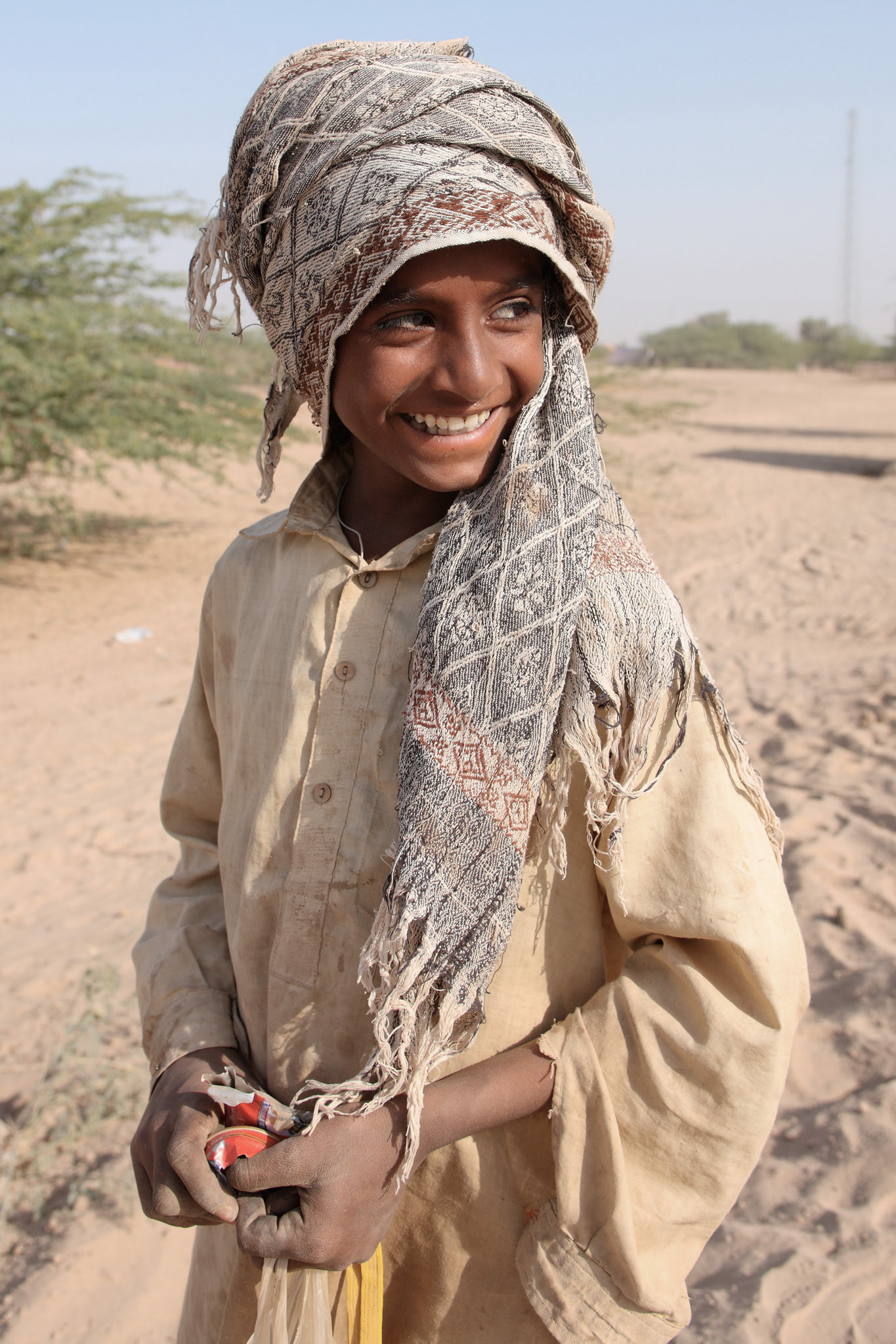 He lives in Cholistan desert as a camel handler. He takes care of his camels and makes a beautiful Cholistan style geometric designs on his camels.