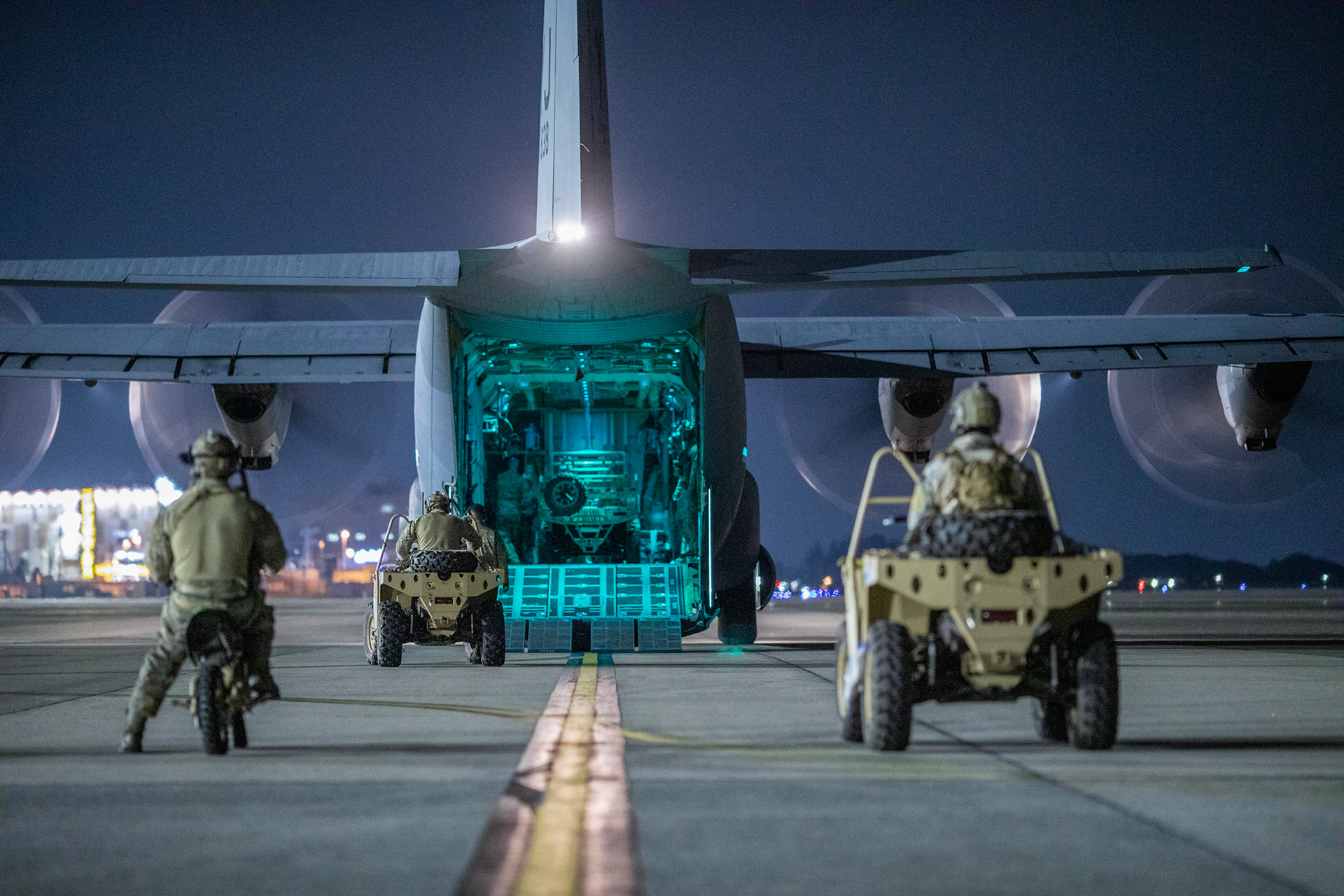 U.S. Air Force Special Tactics operators with the 320th Special Tactics Squadron out of Kadena Air Base, Japan, wait to load their vehicles into a C-130J Super Hercules during an engine running onload/offload (ERO) training as part of Exercise Gryphon Jet at Yokota Air Base, Japan, June 23, 2020. Special Tactics is a U.S. Special Operation Command's tactical air and ground integration force, and the Air Force's special operations ground force, leading Global Access, Precision Strike, Personnel Recovery and Battlefield Surgery operations on the battlefield. Exercise Gryphon Jet is an integrated training exercise focused on improving interoperability throughout the special operations community. (U.S. Air Force photo by Yasuo Osakabe)