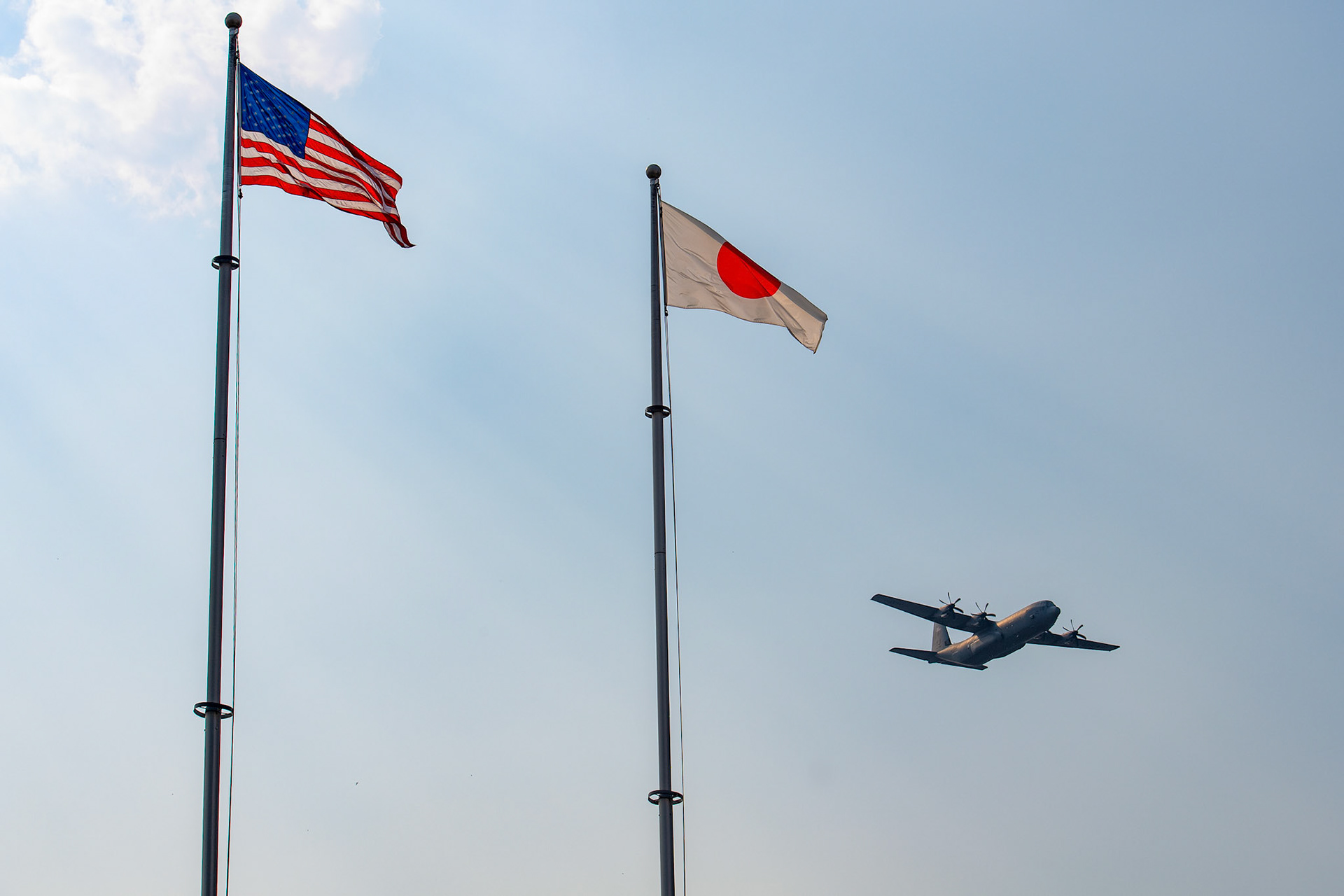 A U.S.Air Force C-130J Super Hercules assigned to the 36th Airlift Squadron flies over Yokota Air Base, Japan, July 18, 2018, during a "fini-flight" for Col. Kenneth Moss, 374th Airlift Wing commander. The "fini-flight" marked Moss's final flight as a commander of the 374th AW. (U.S. Air Force photo by Yasuo Osakabe)