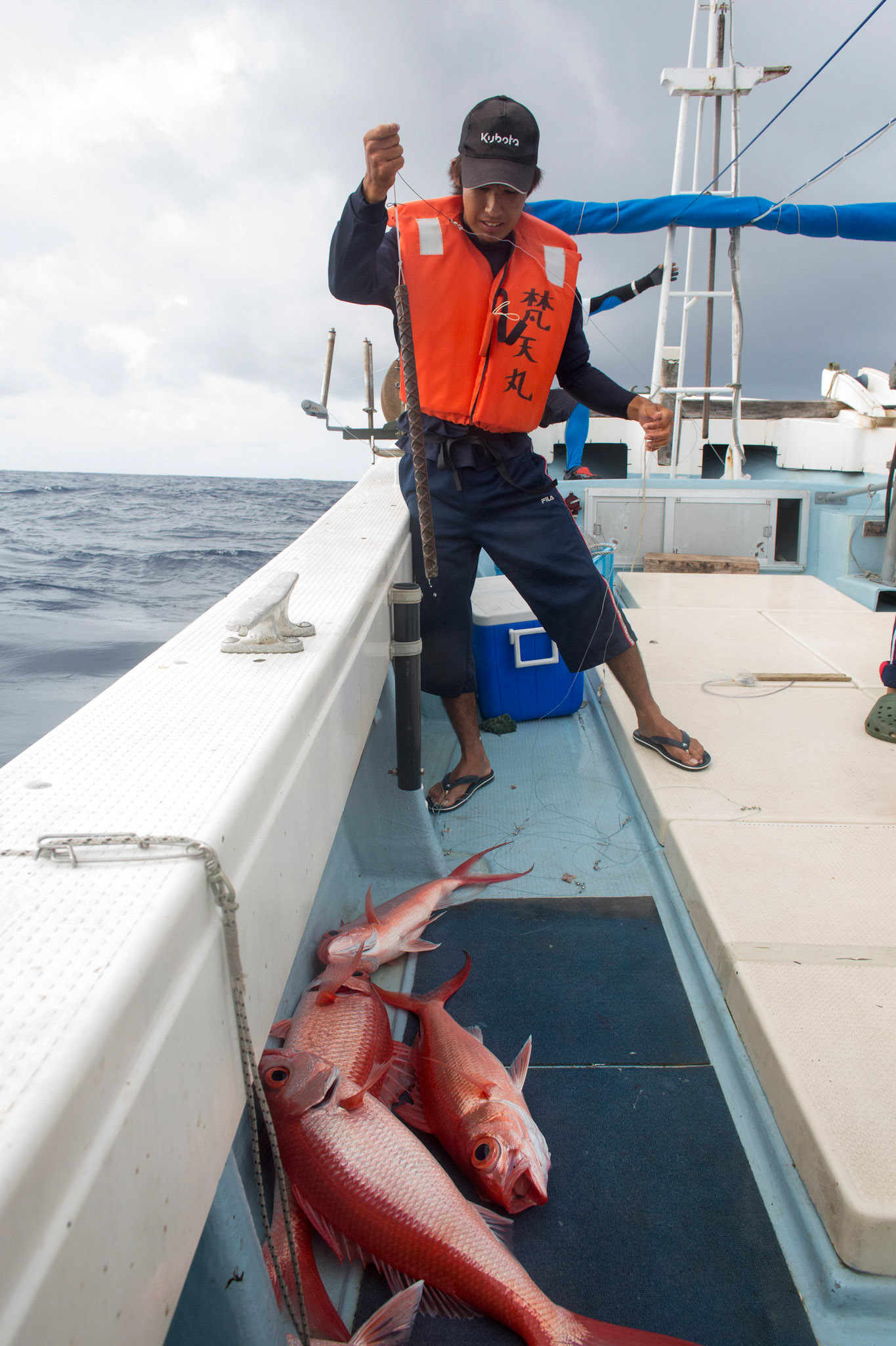 SENKAKU ISLANDS, Japan – A commercial fisherman catches longtailed red snappers at Minami-kojima, Japan, May 26, 2013. “Here is a great fishing ground even though six hours cruising from Ishigaki port. When we cast lines, immediately we catch fishes.” a fisherman told with smile. (Photo by Osakabe Yasuo)