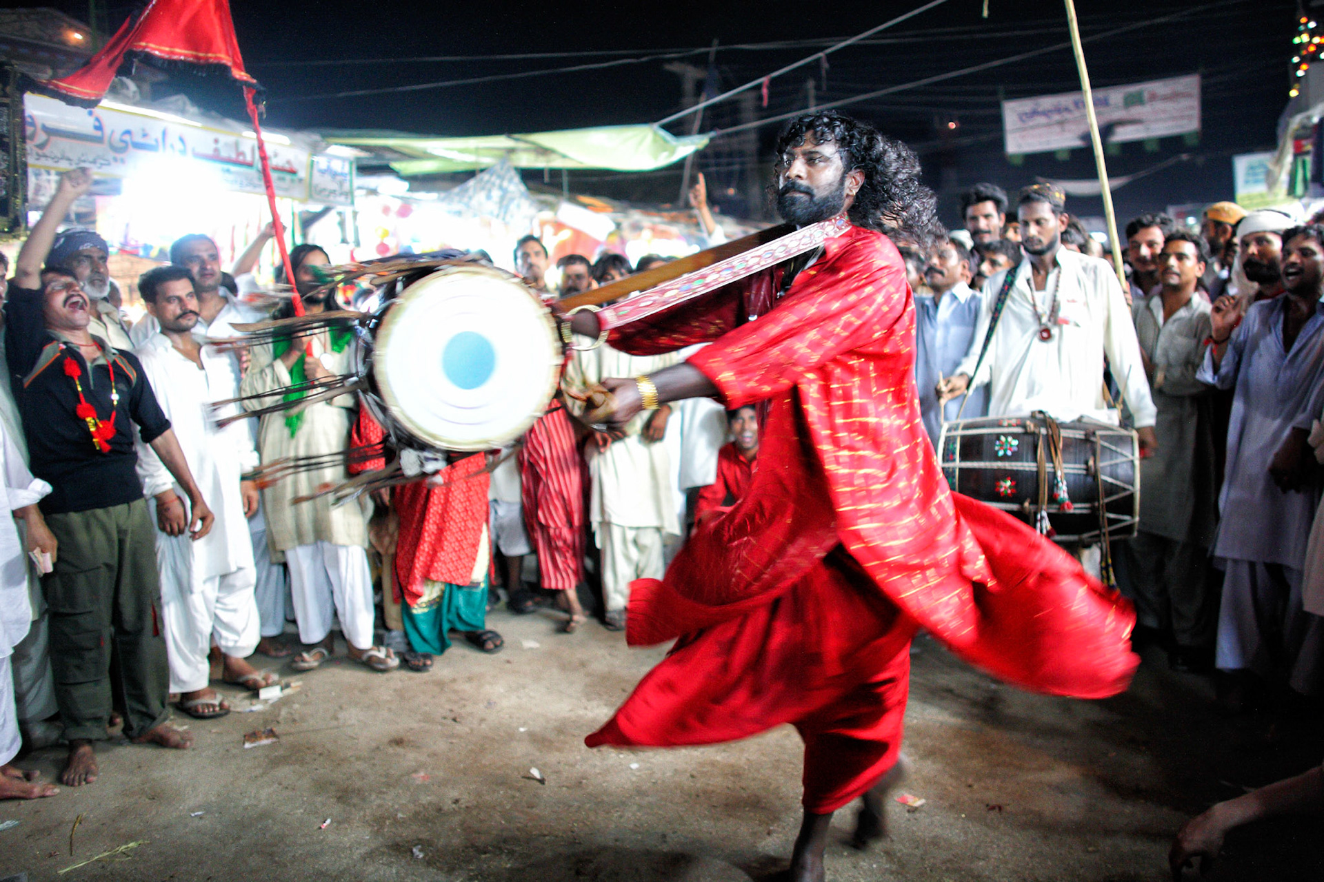 The most exciting moments had come when Gonga sain (centre) had revolved ceaselessly his dhol in the air. Devotees had been shouted Mast Qalandar in trance. (Travel)