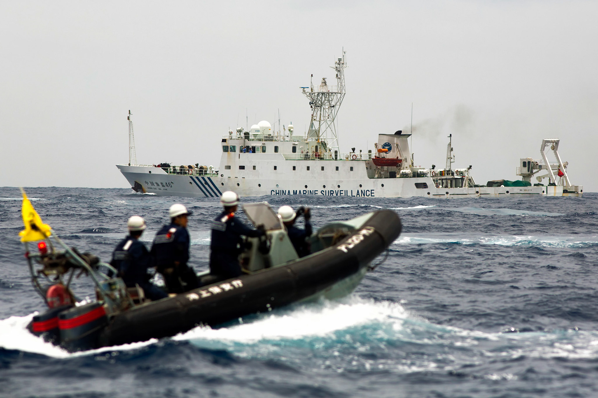 SENKAKU ISLANDS, Japan -- A patrol boat from the Japanese Coast Guard escort a Japanese commercial fishing boat after a Chinese government ships appeared into Japanese territorial waters. Chinese government ships were 46 times intrusion into territorial waters. (Photo by Osakabe Yasuo)