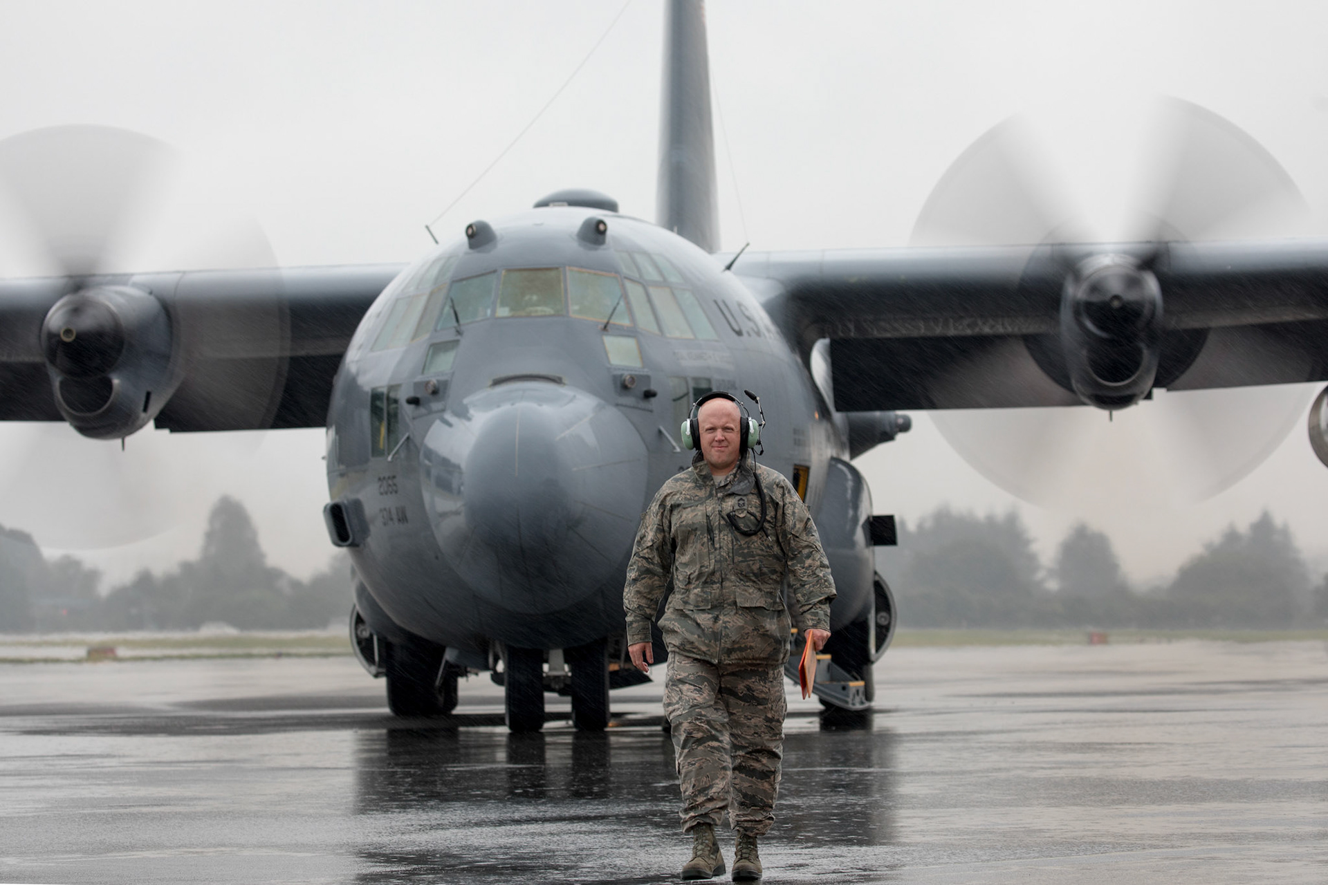 Chief Master Sgt. Eric Evers, 374th Aircraft Maintenance Squadron superintendent, walks on a ramp as he marshals a C-130H Hercules at Yokota Air Base, Japan, Oct. 16, 2017. “It’s a symbol of what American Airmen can produce. It is well used, and the maintenance that has been performed on it for 43 years has enabled it to continue its missions in the hands of our brother’s and sister’s in the Air National Guard.” Said Evers when asked what the H-model means to him. (U.S. Air Force photo by Yasuo Osakabe)
