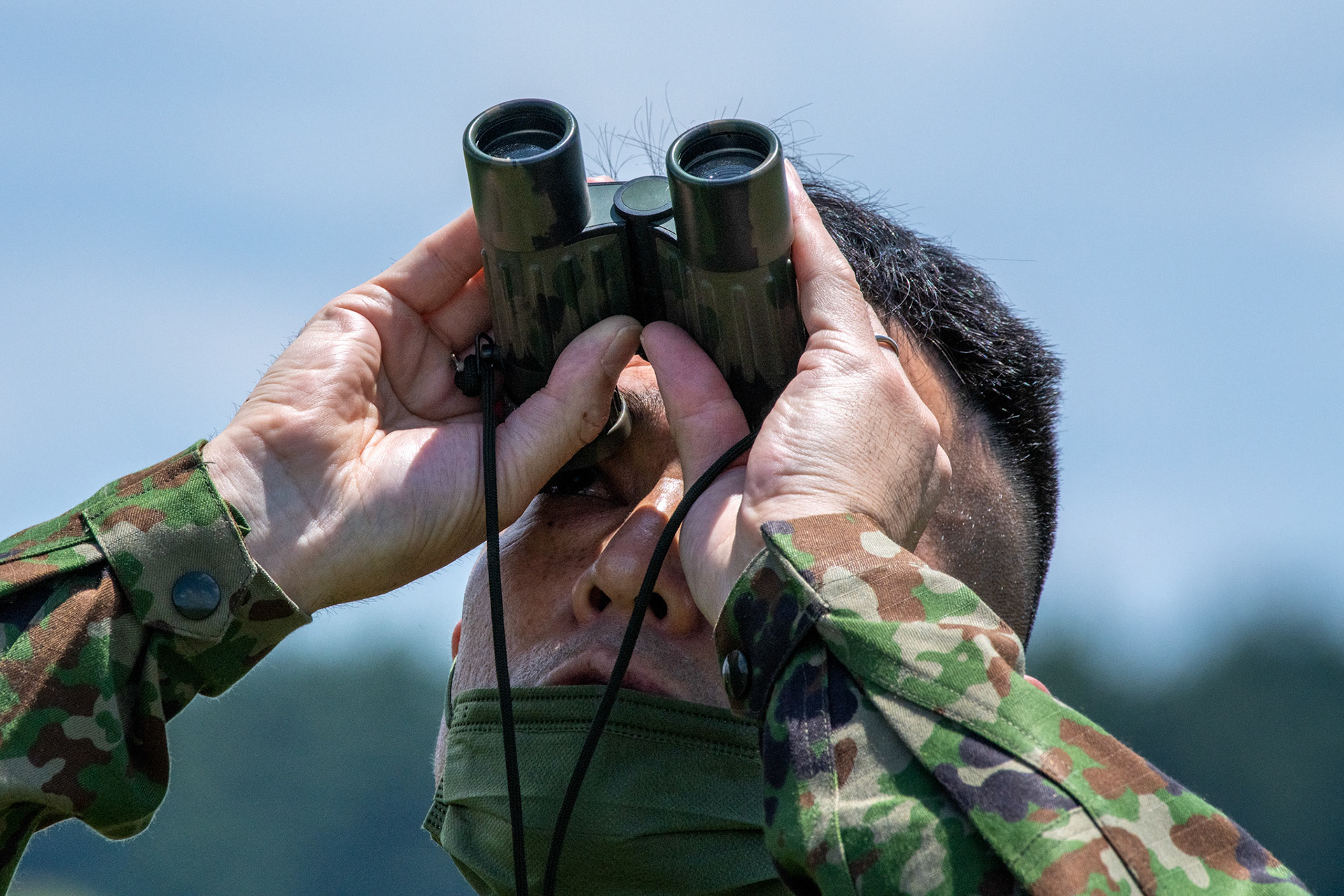 A Japan Ground Self-Defense Force soldier assigned to the 1st Airborne Brigade conducts visual confirmation during the Japanese-American Friendship Festival at Yokota Air Base, Japan, May 22, 2022. A six member team comprised of U.S. Air Force and JGSDF paratroopers, conducted a military free fall demonstration to show their capabilities during the festival. During the two-day festival, more than 110,000 attendees came to Yokota to experience the event. The festival is aimed at increasing bilateral relationships between U.S. and Japanese communities and allows people to see U.S. and Japanese military capabilities first-hand. (U.S. Air Force photo by Yasuo Osakabe)