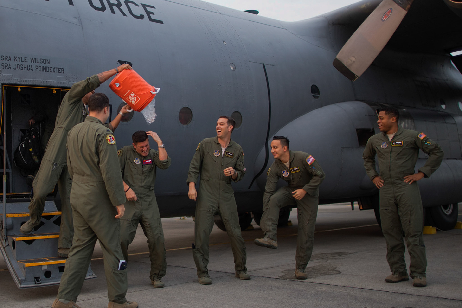 Capt. Andrew Kochman, 36th Airlift Squadron navigator, gets doused with a bucket of ice water following the C-130H Hercules' last tactical training sortie at Yokota Air Base, Japan, Oct. 5, 2017. Yokota's C-130H fleet is being replace by the newer C-130J Super Hercules. (U.S. Air Force photo by Yasuo Osakabe)