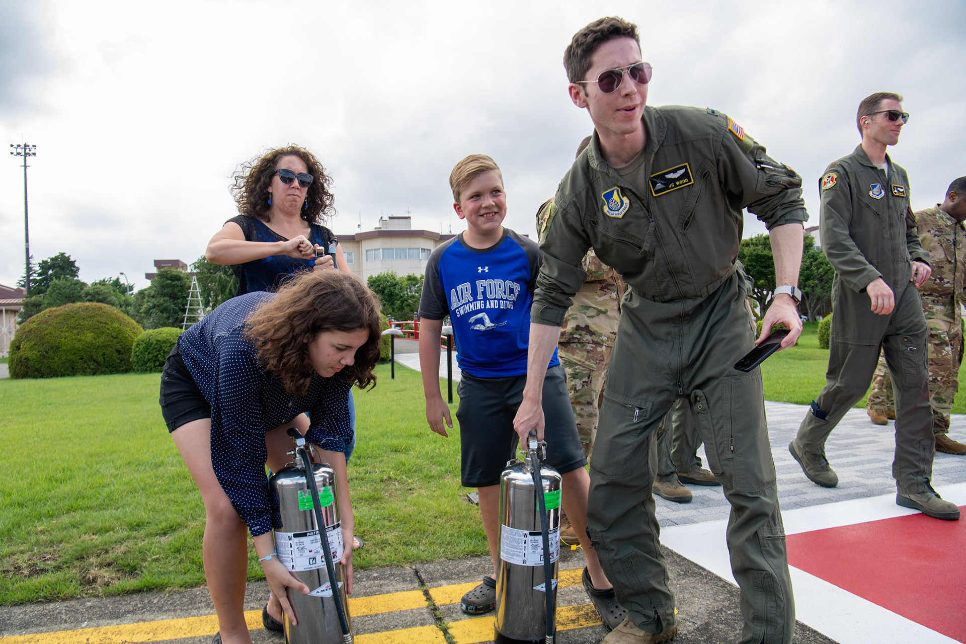 1st Lt. John Wood, 36th Airlift Squadron C-130J pilot, along with Col. Barry King’s family: Karen King (wife), Athena King (daughter) and Justin King (son) prepare to greet Col. King after his final flight at Yokota Air Base, Japan, July 23, 2019. Family and friends gathered to celebrate King’s twenty-one years of service. (U.S. Air Force photo by Yasuo Osakabe)