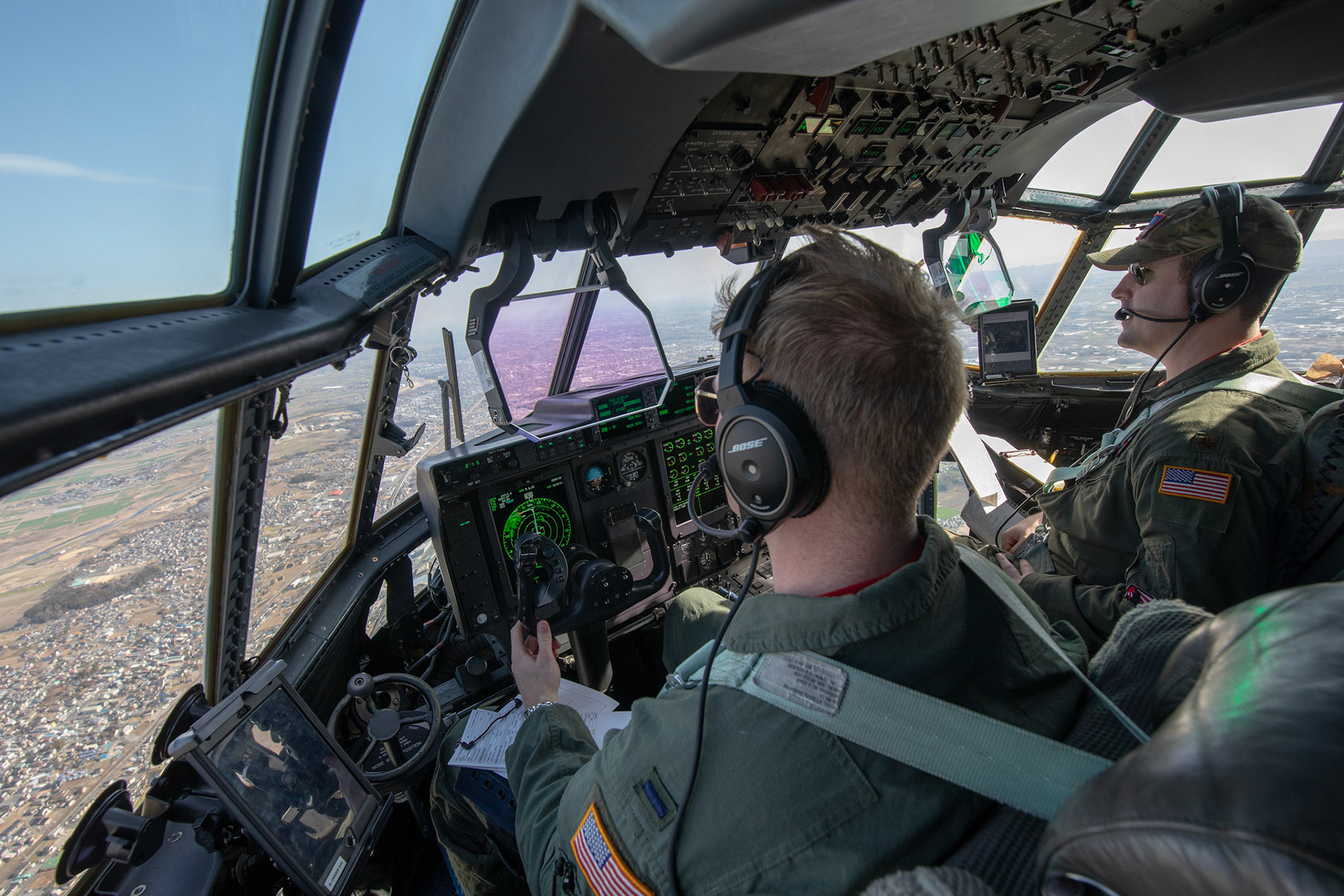 (Left to right) 1st Lt. Matthew Crader and Maj. Daniel Gnazzo, both with the 36th Airlift Squadron C-130J pilots, fly during the Yokota C-130J Rodeo over the Kanto Plain, March 22, 2019. The 36th Airlift Squadron held a tactical airlift Rodeo competition to test and improve combat tactics in a competitive environment with a split focus on pilot and loadmaster skills. (U.S. Air Force photo by Yasuo Osakabe)