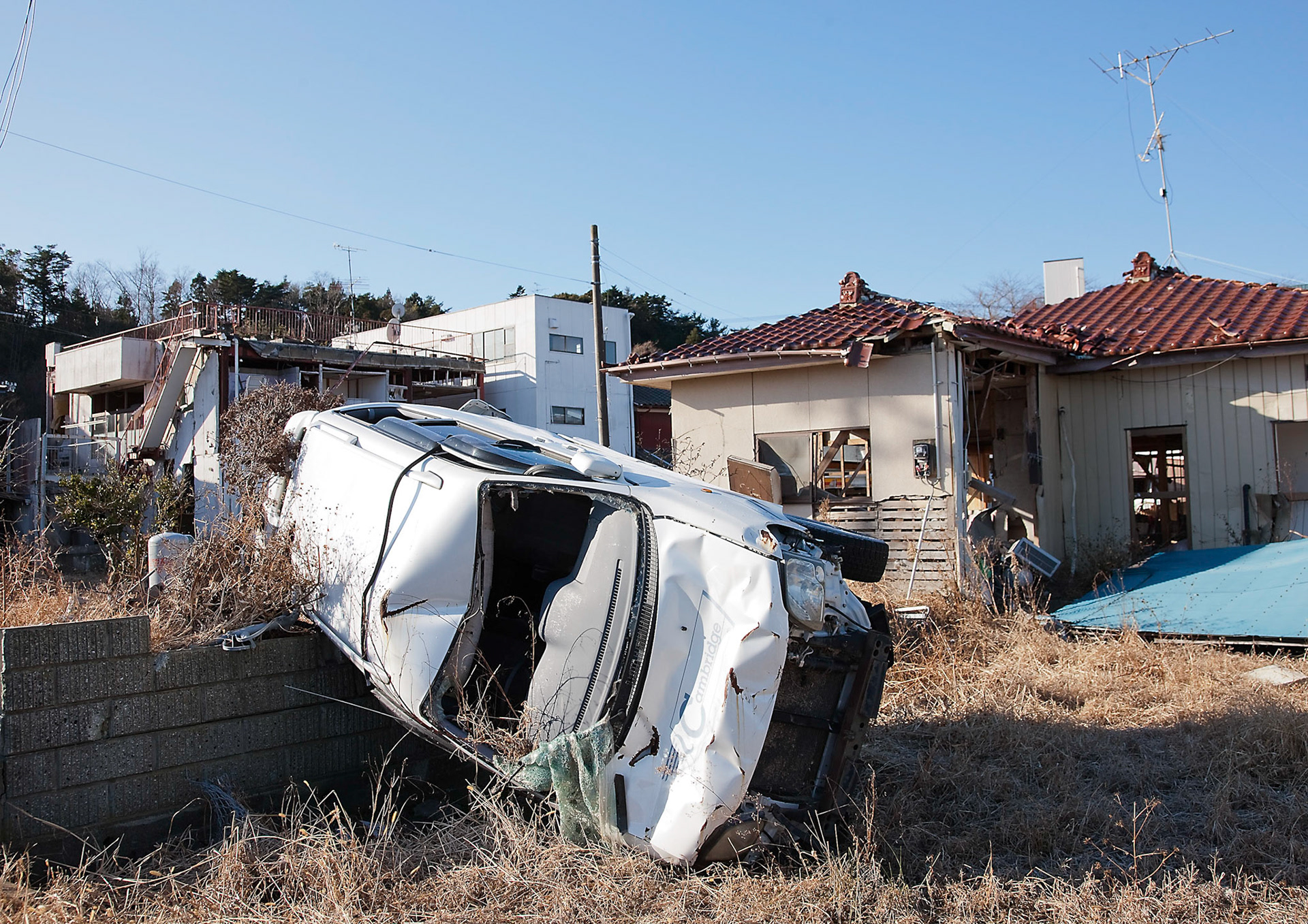 FUKUSHIMA EXCLUSION ZONE, Japan -- Destoryed car and houses by Tsunami on March 11, 2011 abandoned inside the exclusion zone, Tomioka, Fukushima prefecture, Japan, Jan. 8, 2012. Tomioka is inside the exclusion zone, which has been established 20 Kilometers around the site of the Fukushima Daiichi Nuclear Power Plant following the Great East Japan Earthquake and the Fukushima nuclear disaster. (Osakabe Yasuo)