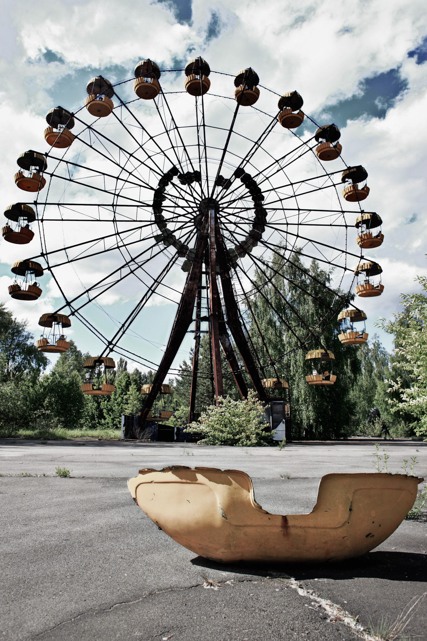 The Ferris wheel stands in the Fairground in the Chernobyl Exclusion Zone, Pripyat. The fairground was scheduled to officially open to the public on May 1, 1986. The citizens of Pripyat began to evacuate on 27 April, more than 24 hours after the explosion. The park have never chanced to open officially..... and the radioactive level here still remains more 1000 times higher than outside of the reactor 4, Chernobyl Nuclear Power Plant.