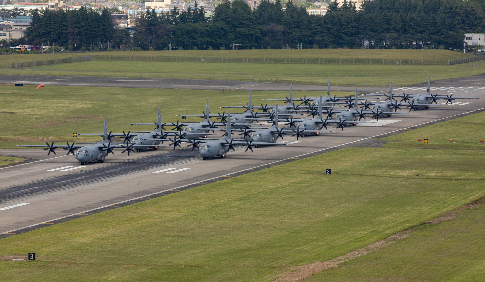 Twelve C-130J Super Hercules from the 36th Airlift Squadron prepare to takeoff during the 374th Airlift Wing (AW) Generation Exercise Elephant Walk at Yokota Air Base, Japan, May 4, 2018.  The 374th AW maintains and operates the C-130J Super Hercules, C-12 Huron, and UH-1N Iroquois, making it the primary Western Pacific airlift hub for U.S. Air Force peacetime and contingency operations. (U.S. Air Force photo by Yasuo Osakabe)