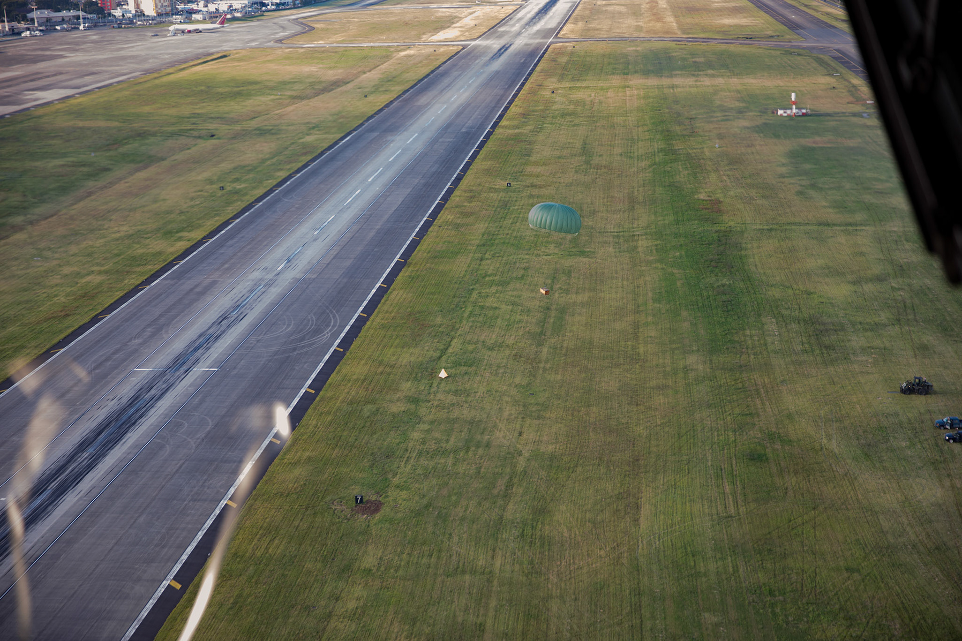 A low-cost, low-altitude bundle falls to the drop zone at Yokota Air Base, Japan, Oct. 5, 2017. This is the last time active duty C-130H Hercules' crew members perform an LCLA airdrop. (U.S. Air Force photo by Yasuo Osakabe)